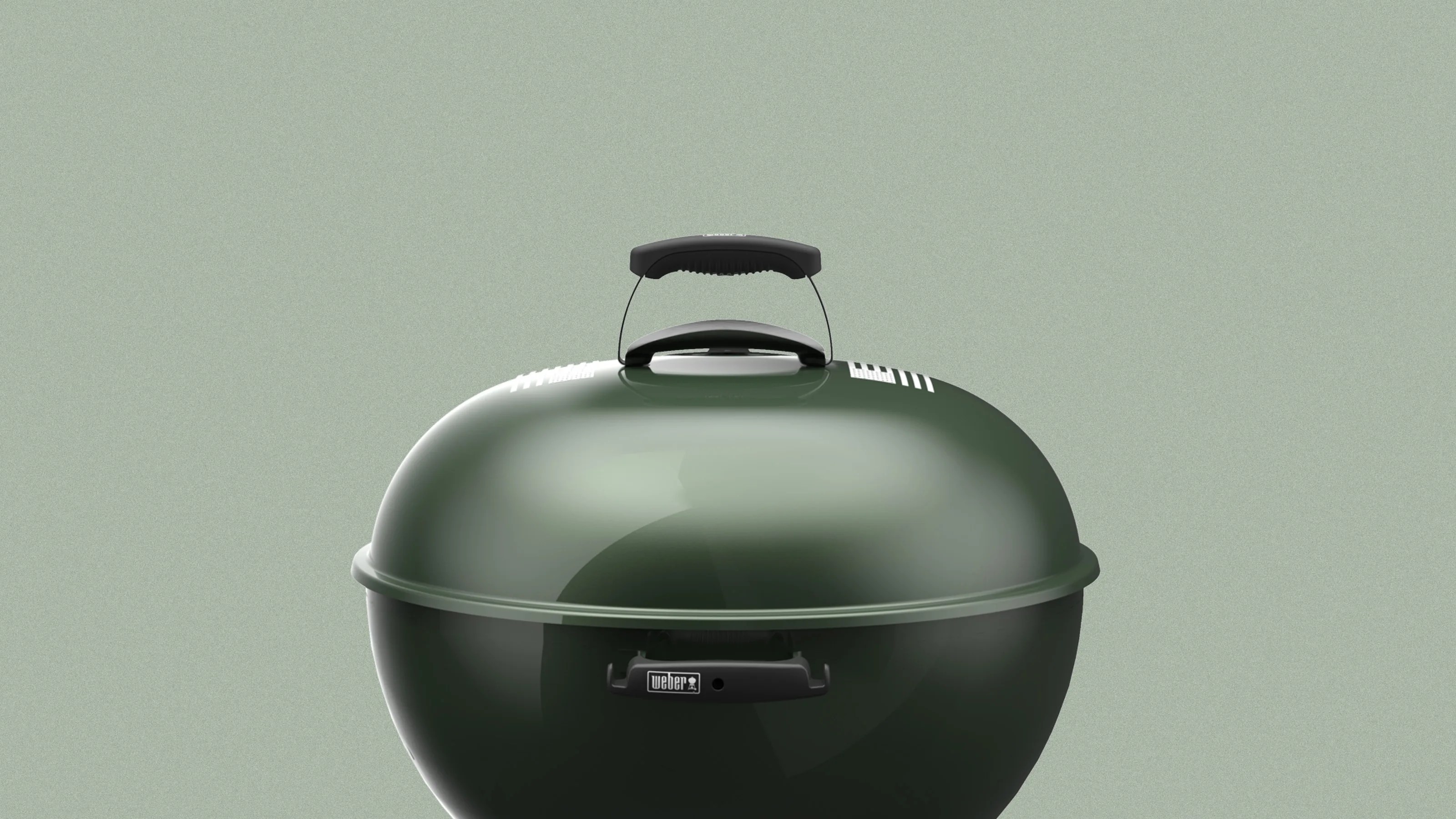 Glossy dark green kettle charcoal grill lid with black handle and Weber logo on front handle.