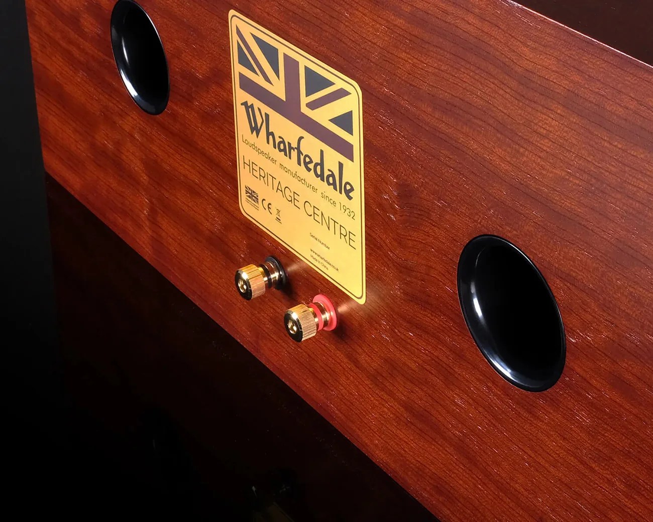 Wood-finished Wharfedale Heritage Centre speaker back panel with two black oval ports and gold speaker terminals.