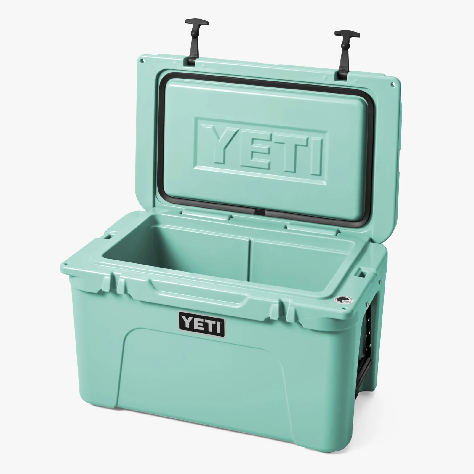 Light teal YETI cooler with open lid showing black rubber seal and divided interior.