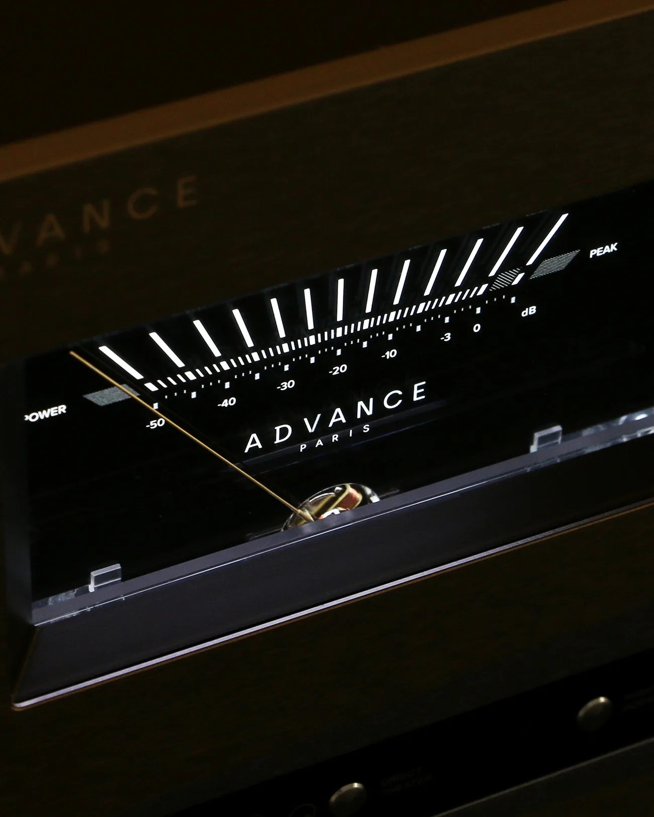 Close-up of an Advance Paris audio level meter with a needle pointing near -50 dB on a black panel.