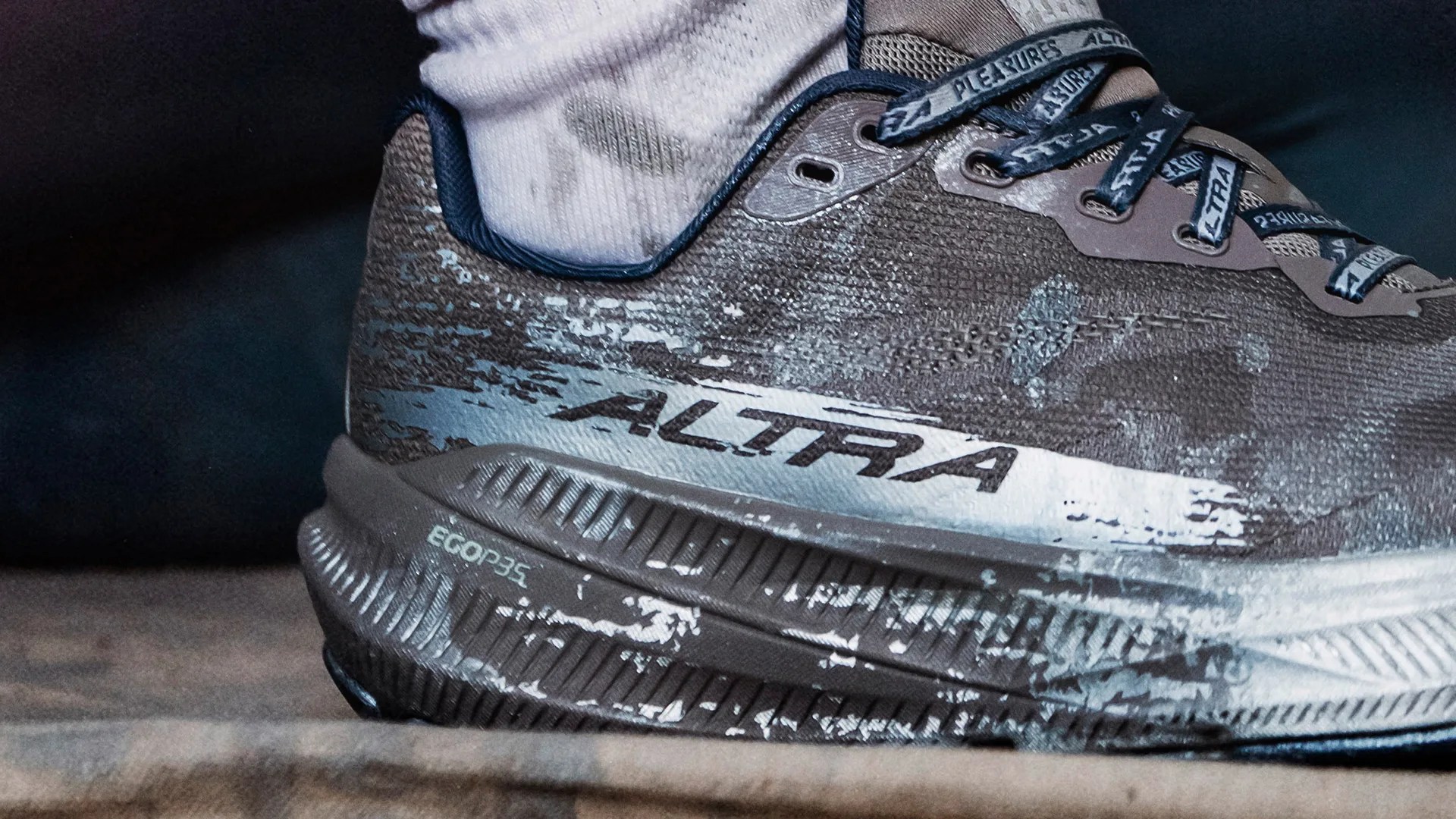 Close-up of a brown and gray Altra running shoe with "EGOP35" on the sole and branded laces.