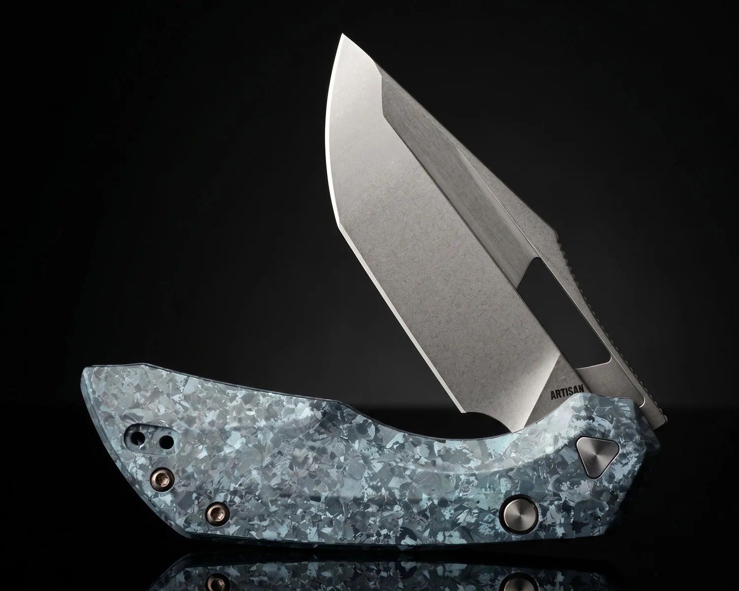Folding knife with a textured blue-gray handle and a partially open, stonewashed blade marked "ARTISAN.