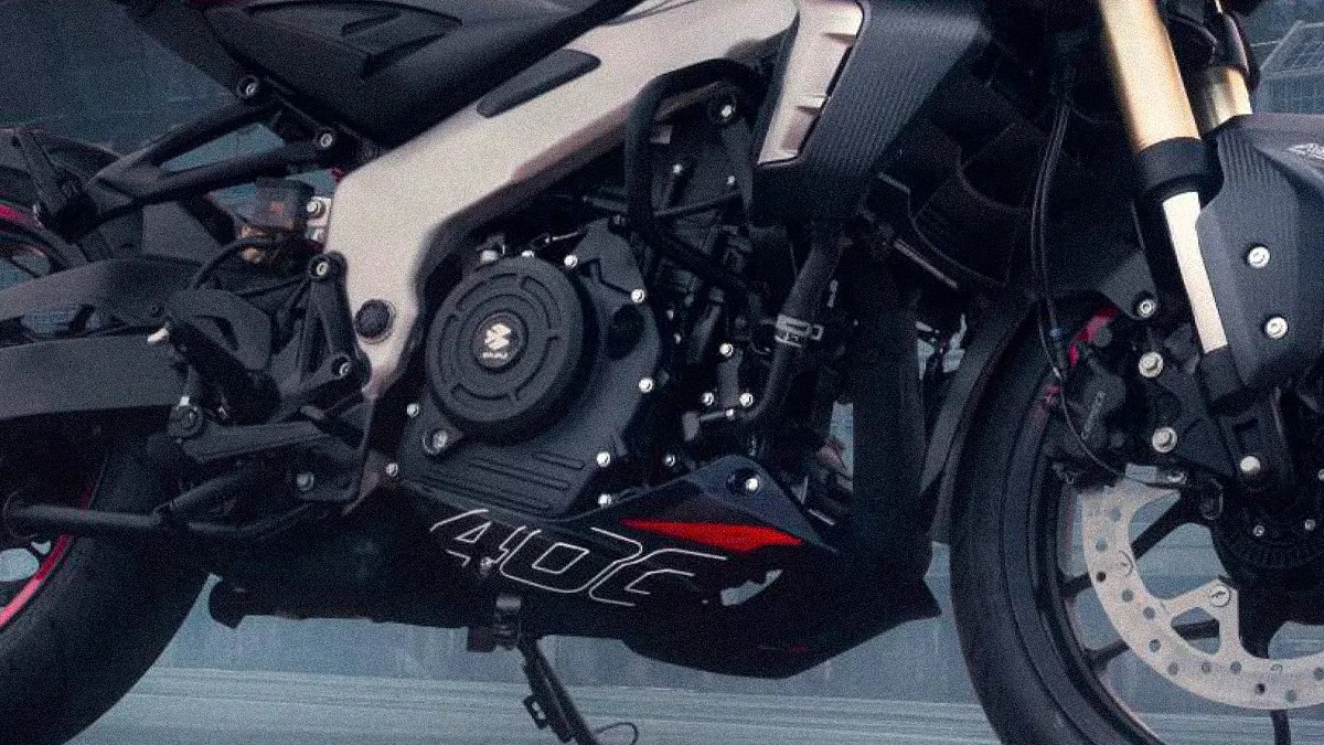 Close-up of a black motorcycle engine with "400" decal and part of the front wheel with disc brake.