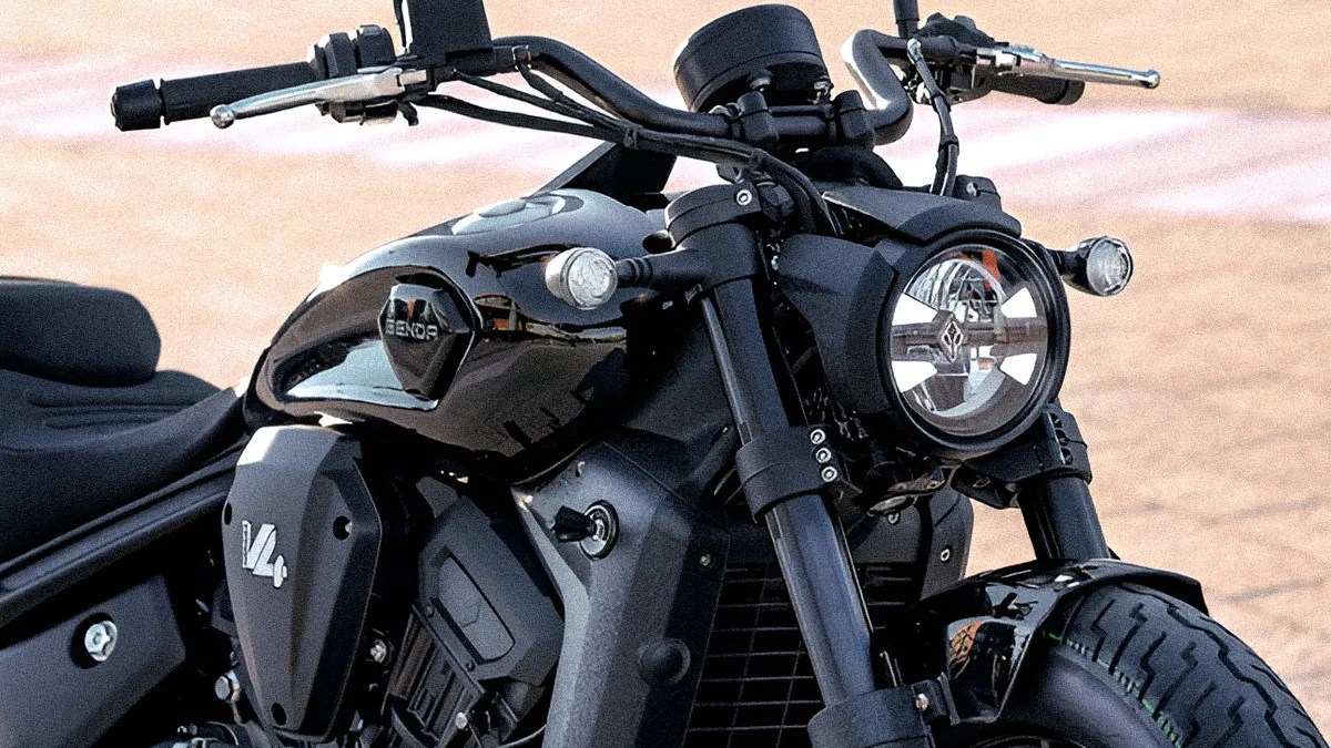 Close-up of a black Renegade V4S motorcycle front with round headlight and turn signals.