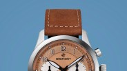Close-up of a Bremont watch with a brown leather strap and copper-colored textured dial.