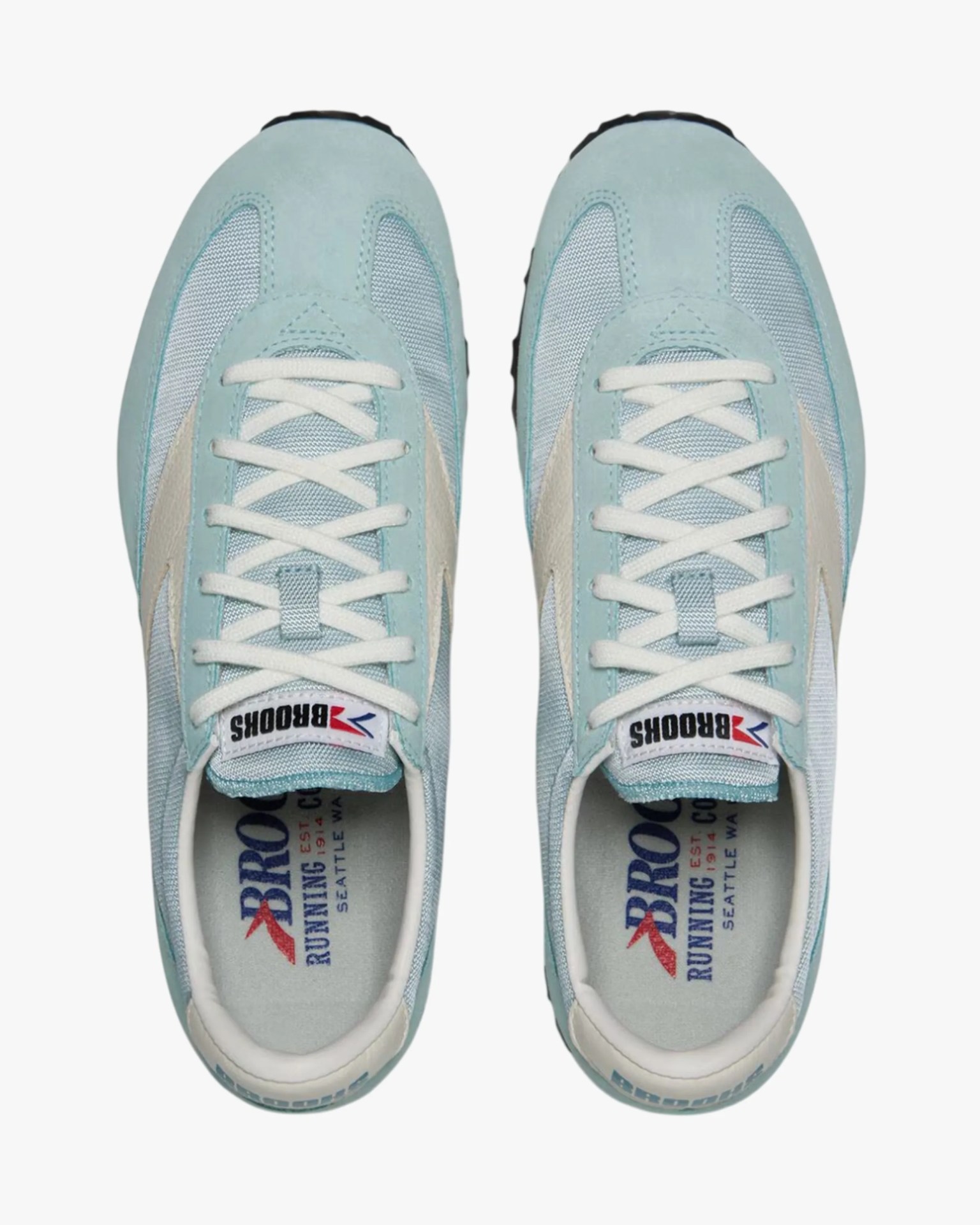 Pair of light blue Brooks running shoes with white laces and beige side accents, viewed from above.
