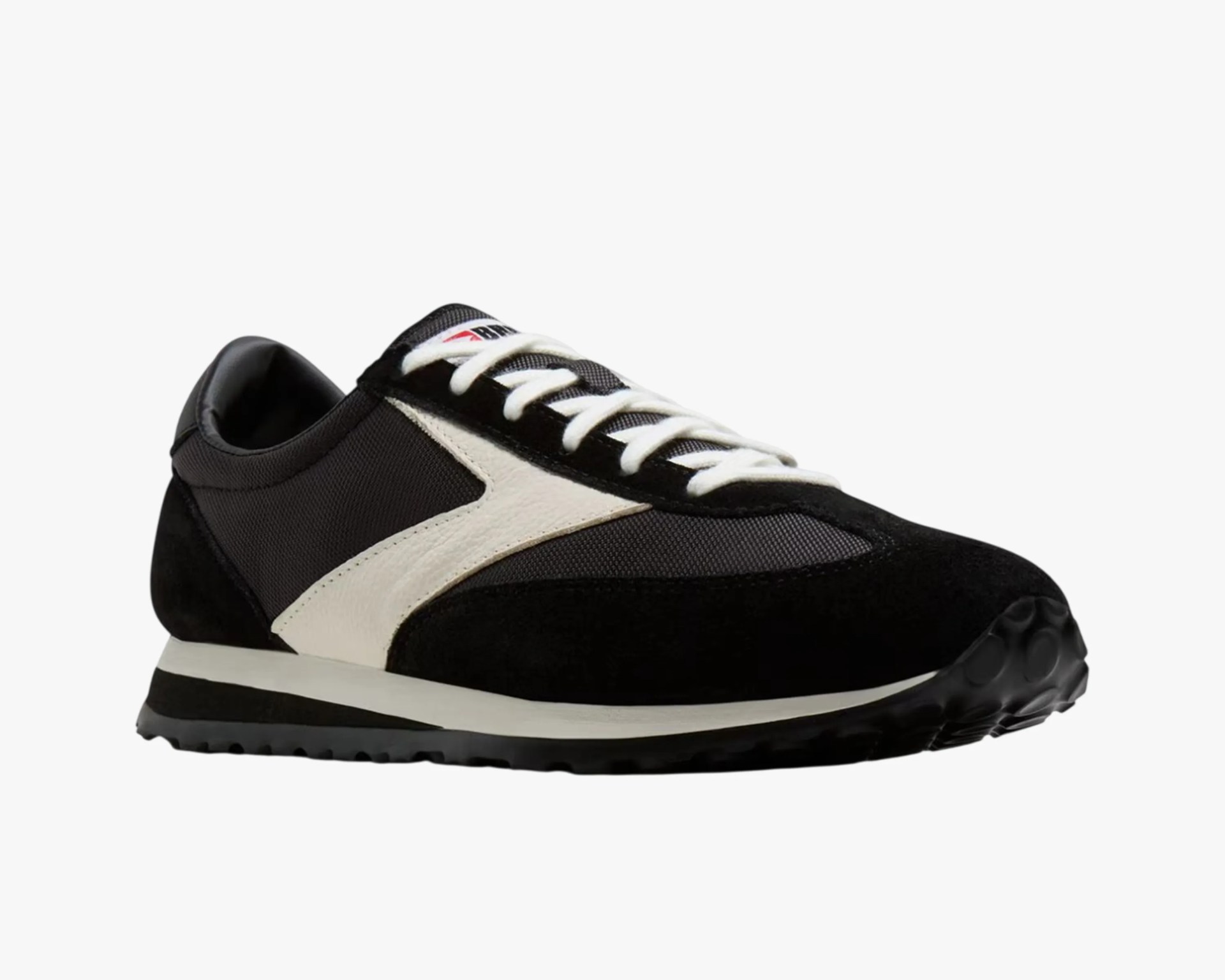 Black and white low-top sneaker with white laces and textured sole.