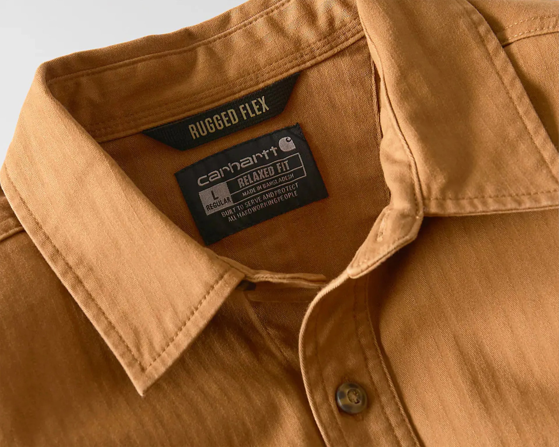Close-up of a brown Carhartt Rugged Flex shirt collar with visible size and fit labels.