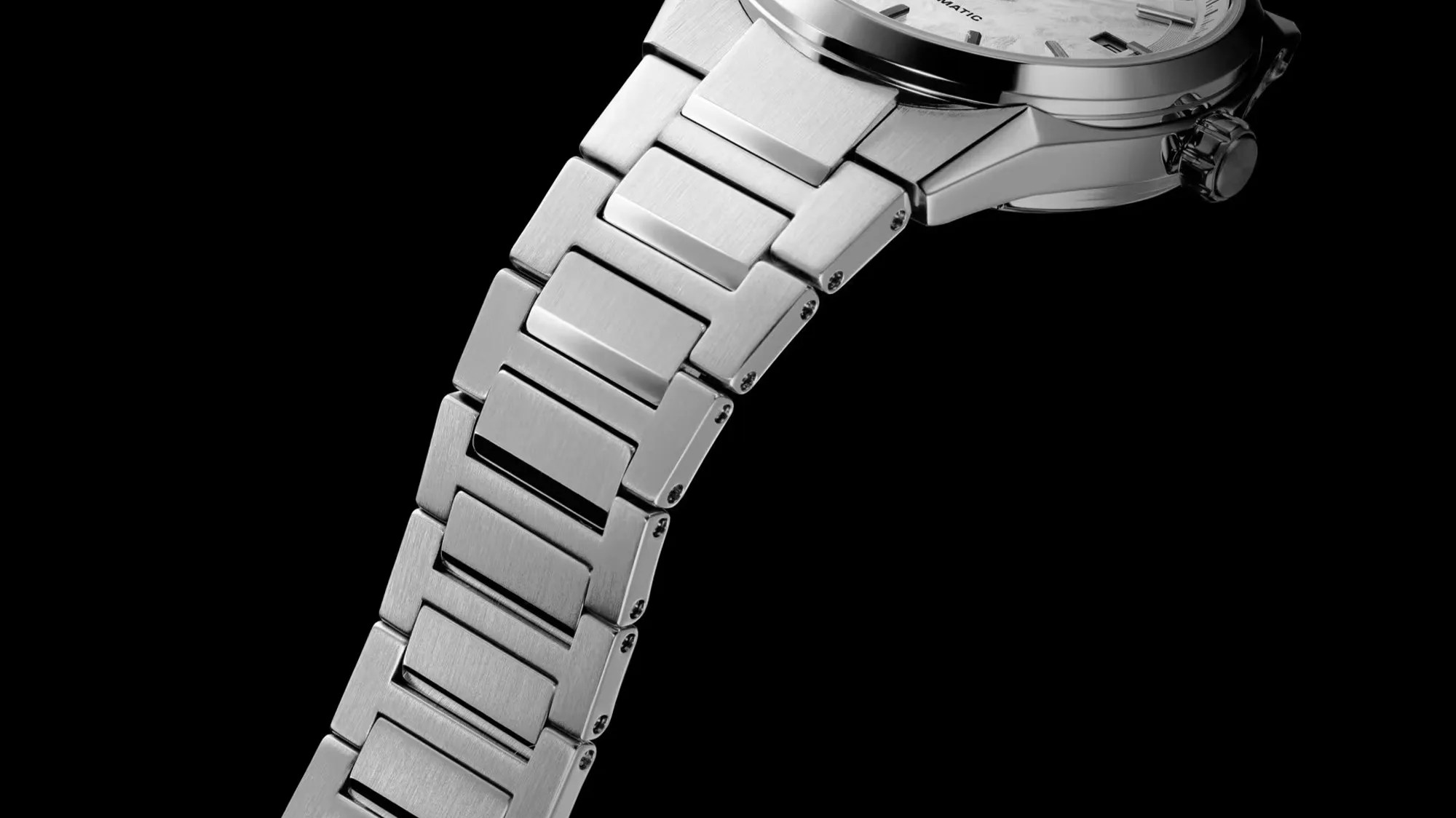 Close-up of a silver stainless steel watch band with brushed finish links against a black background.