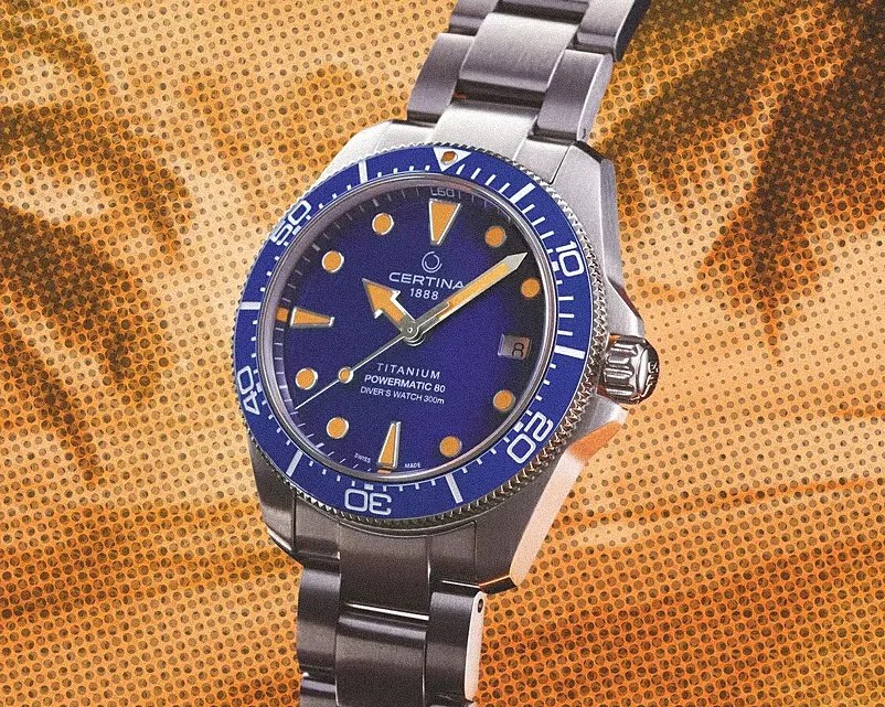 Titanium Certina Powermatic 80 diver's watch with blue dial and bezel on a metal bracelet.