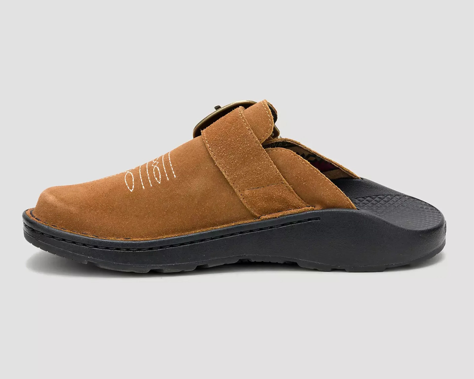 Brown suede slip-on clog with black textured sole and adjustable strap.