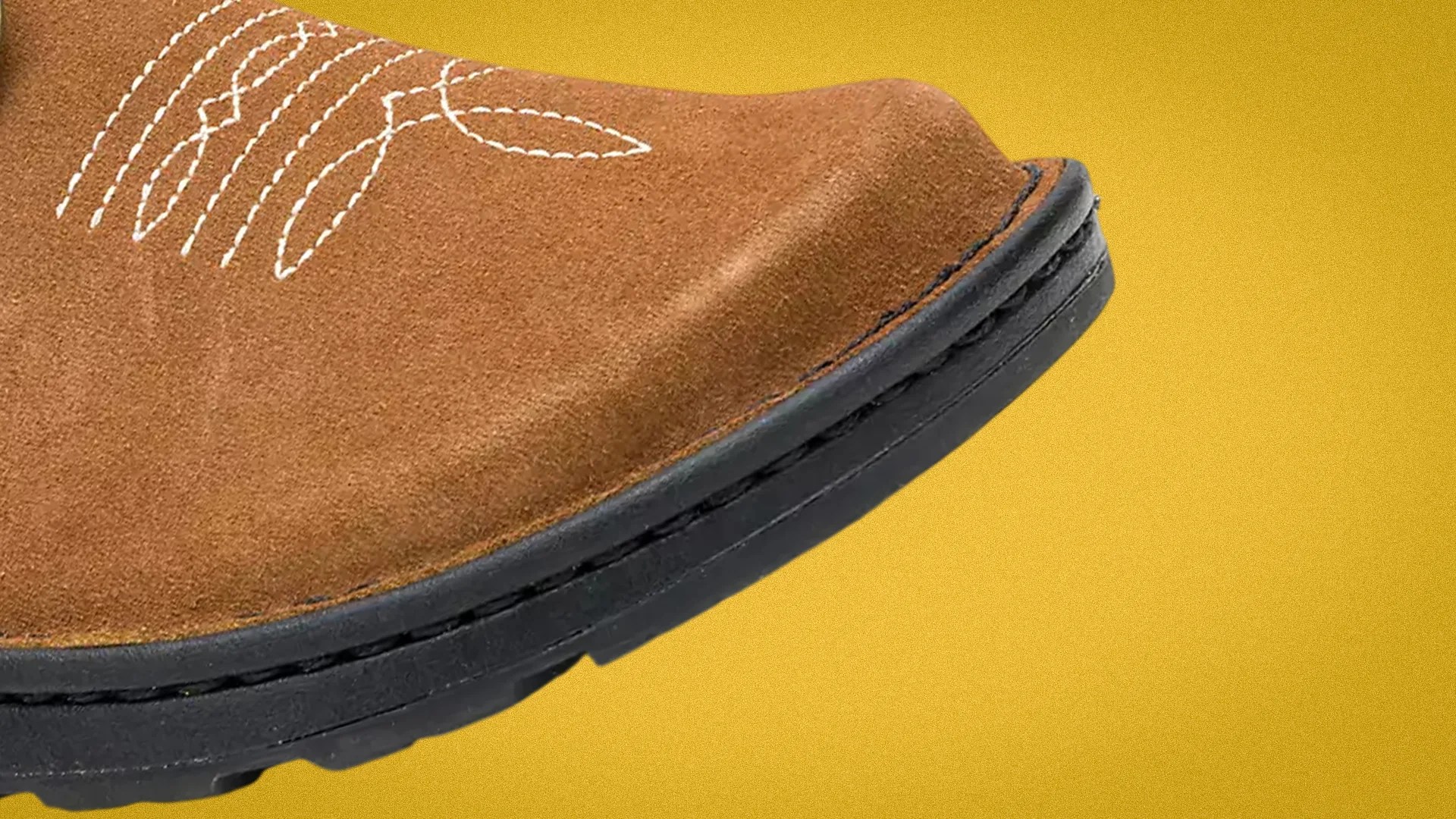Close-up of a brown suede shoe toe with white stitching and a black rubber sole on a yellow background.