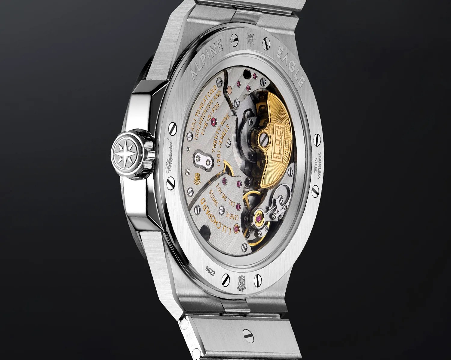 Back of a stainless steel Chopard Alpine Eagle watch showing the intricate mechanical movement with gold and silver components.