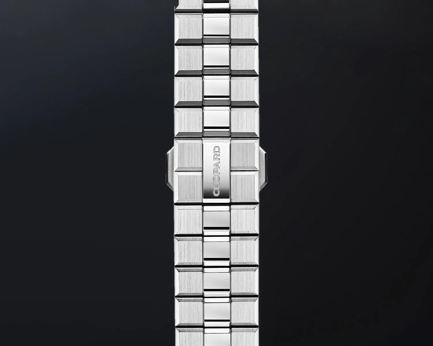 Polished and brushed stainless steel watch bracelet with "CHOPARD" engraved on the clasp.