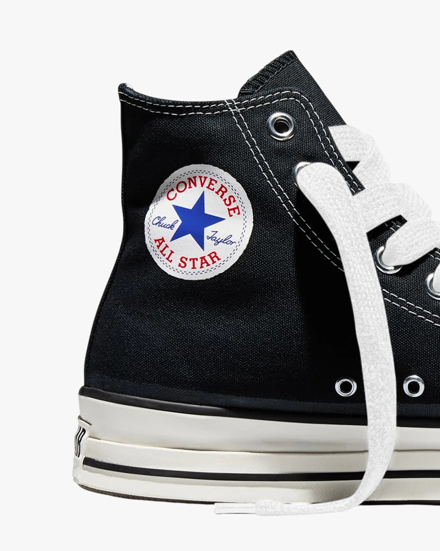 Black high-top Converse Chuck Taylor All Star sneaker with white laces and sole, showing the logo patch.