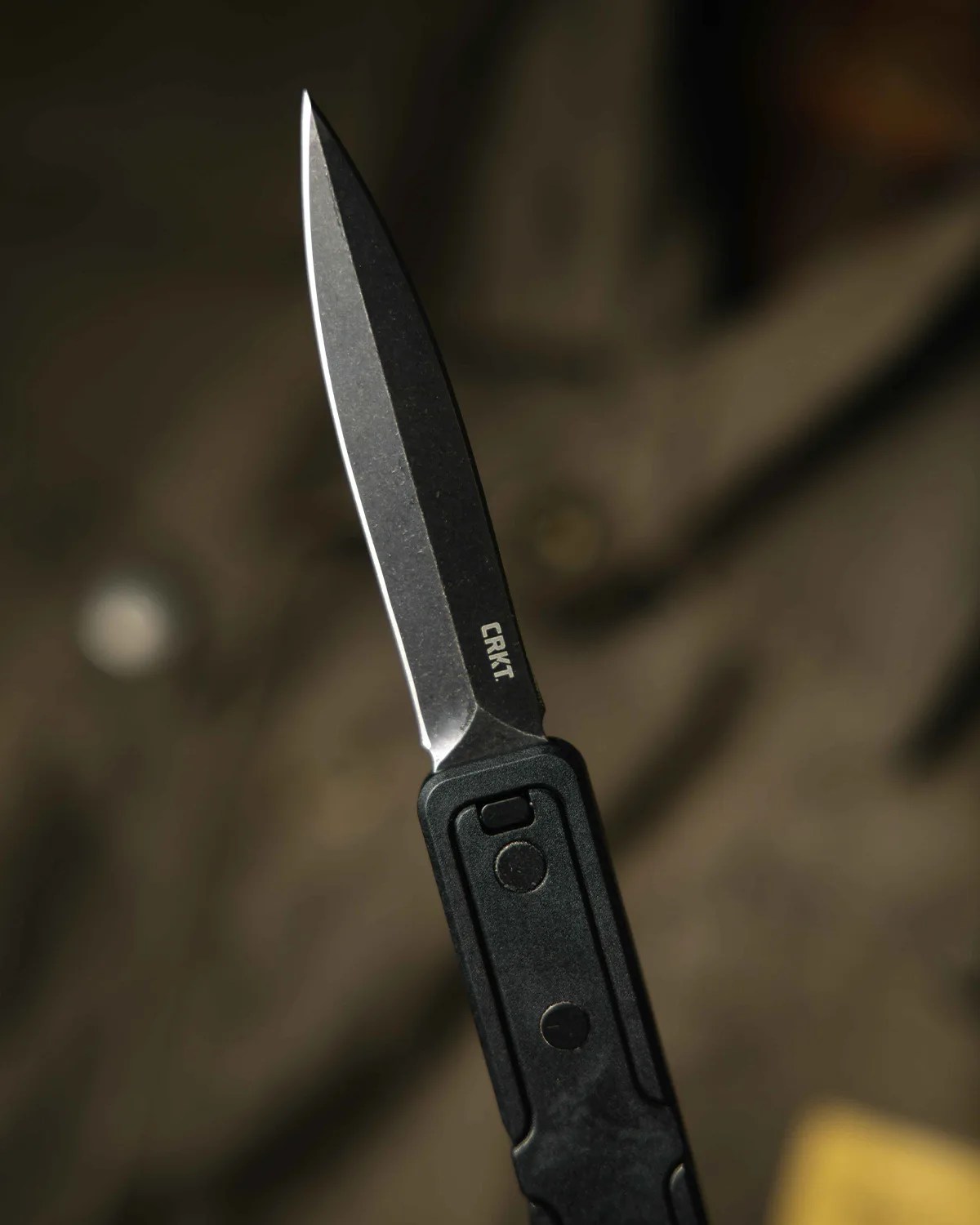 Black folding knife with stonewashed blade and "CRKT" logo on the blade.