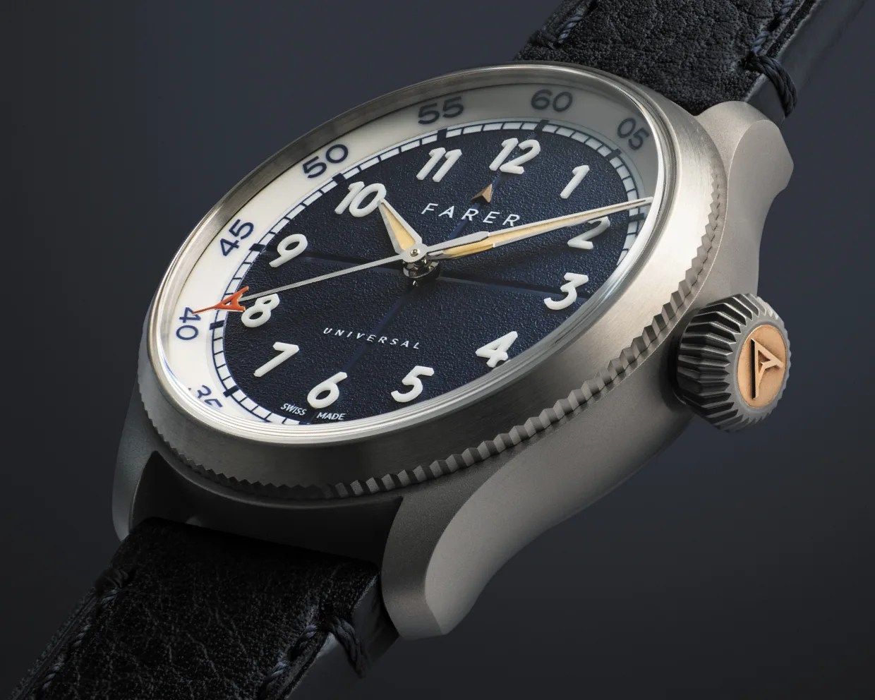 Close-up of a Farer Universal watch with a textured navy dial, white numerals, silver case, and black leather strap.