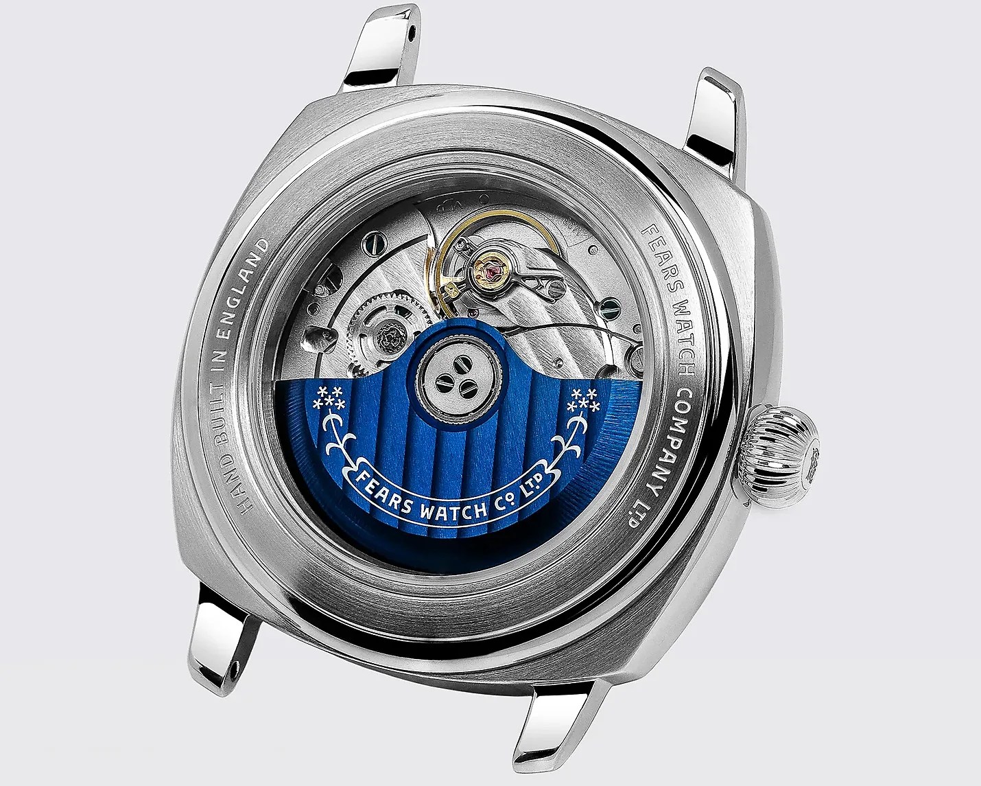 Silver watch case back showing mechanical movement with blue rotor engraved "Fears Watch Co. Ltd" and text "Hand Built in England" and "Fears Watch Company Ltd" around the edge.