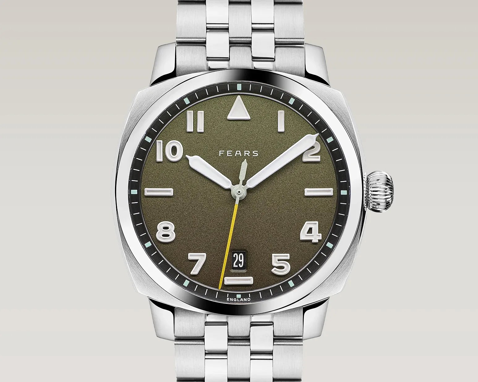 Silver metal wristwatch with olive green dial, white numerals, yellow second hand, and date display at 6 o'clock.