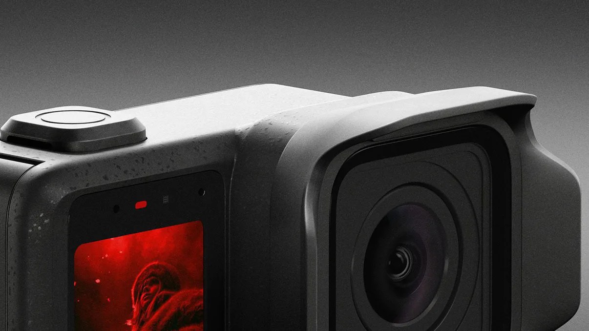 Close-up of a black action camera with a large lens and a small screen displaying a red-tinted image.