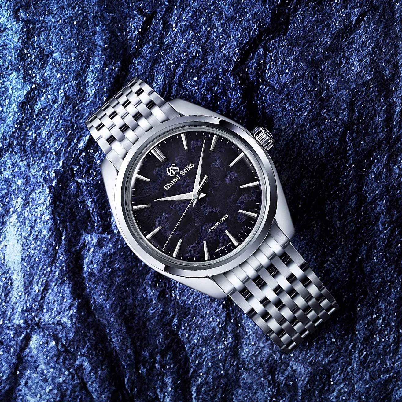 Grand Seiko stainless steel wristwatch with a textured dark blue dial and silver hour markers on a matching metal bracelet.