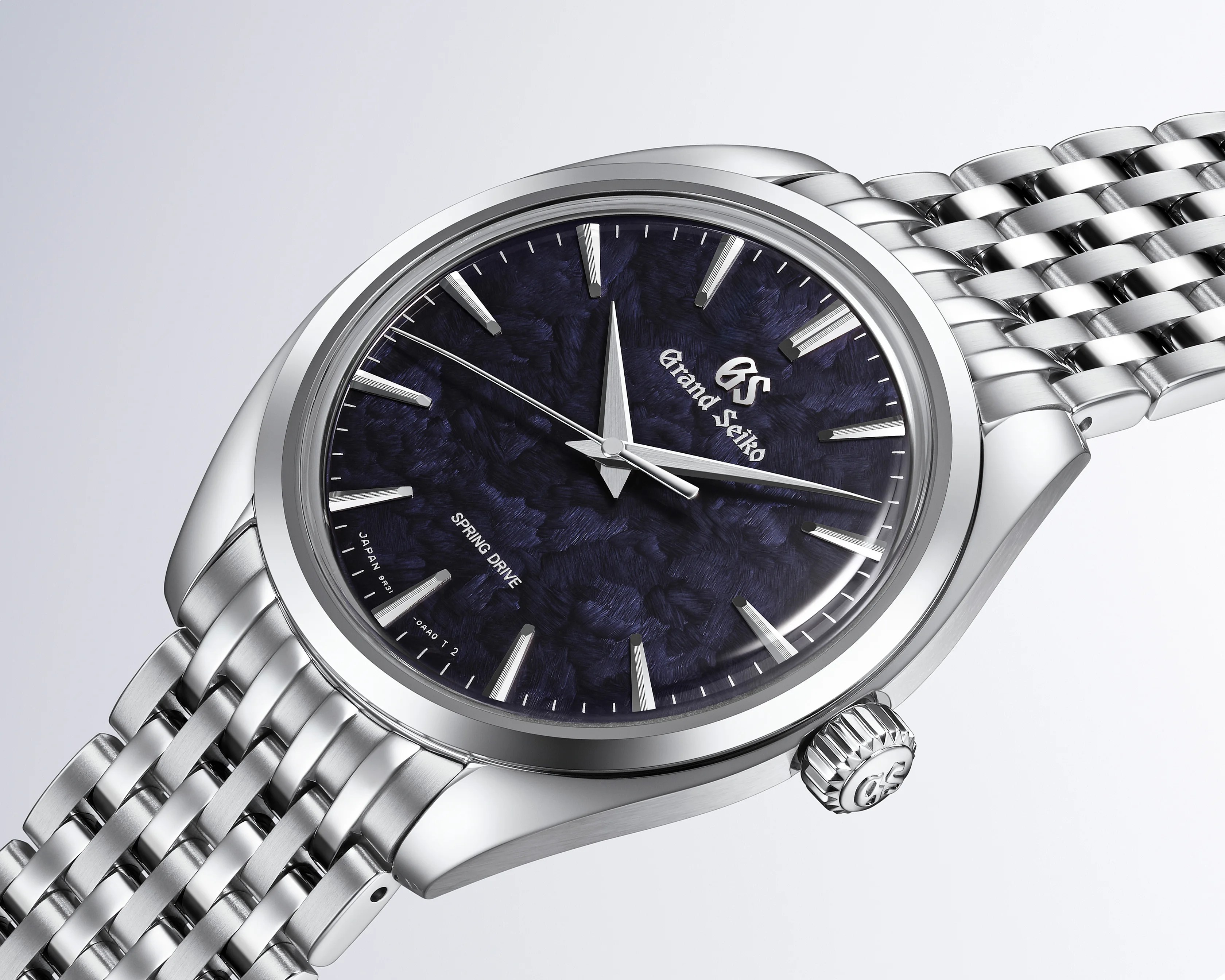 Silver stainless steel Grand Seiko wristwatch with a textured dark blue dial and silver hour markers.
