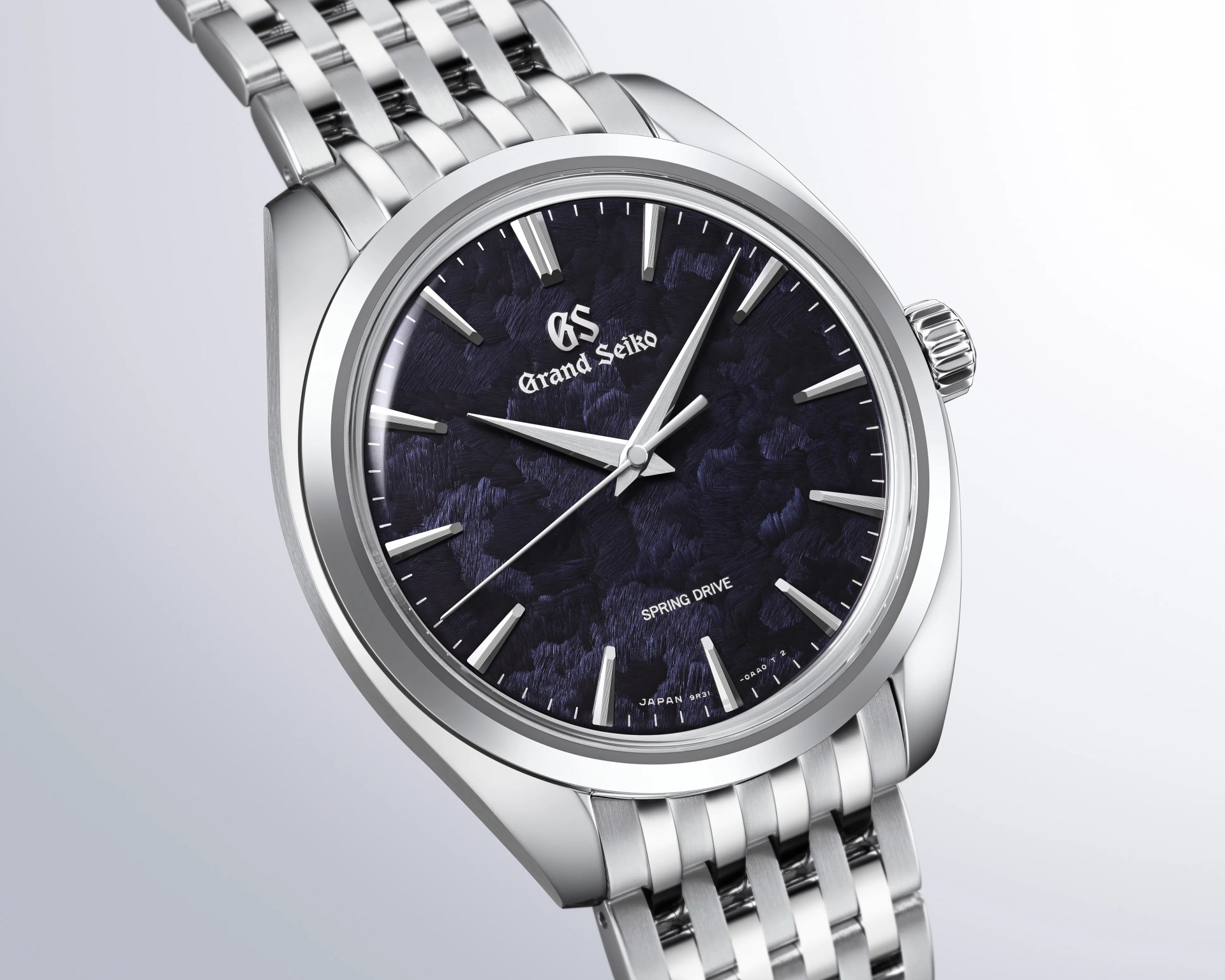 Silver stainless steel Grand Seiko wristwatch with textured dark blue dial and silver hour markers and hands.