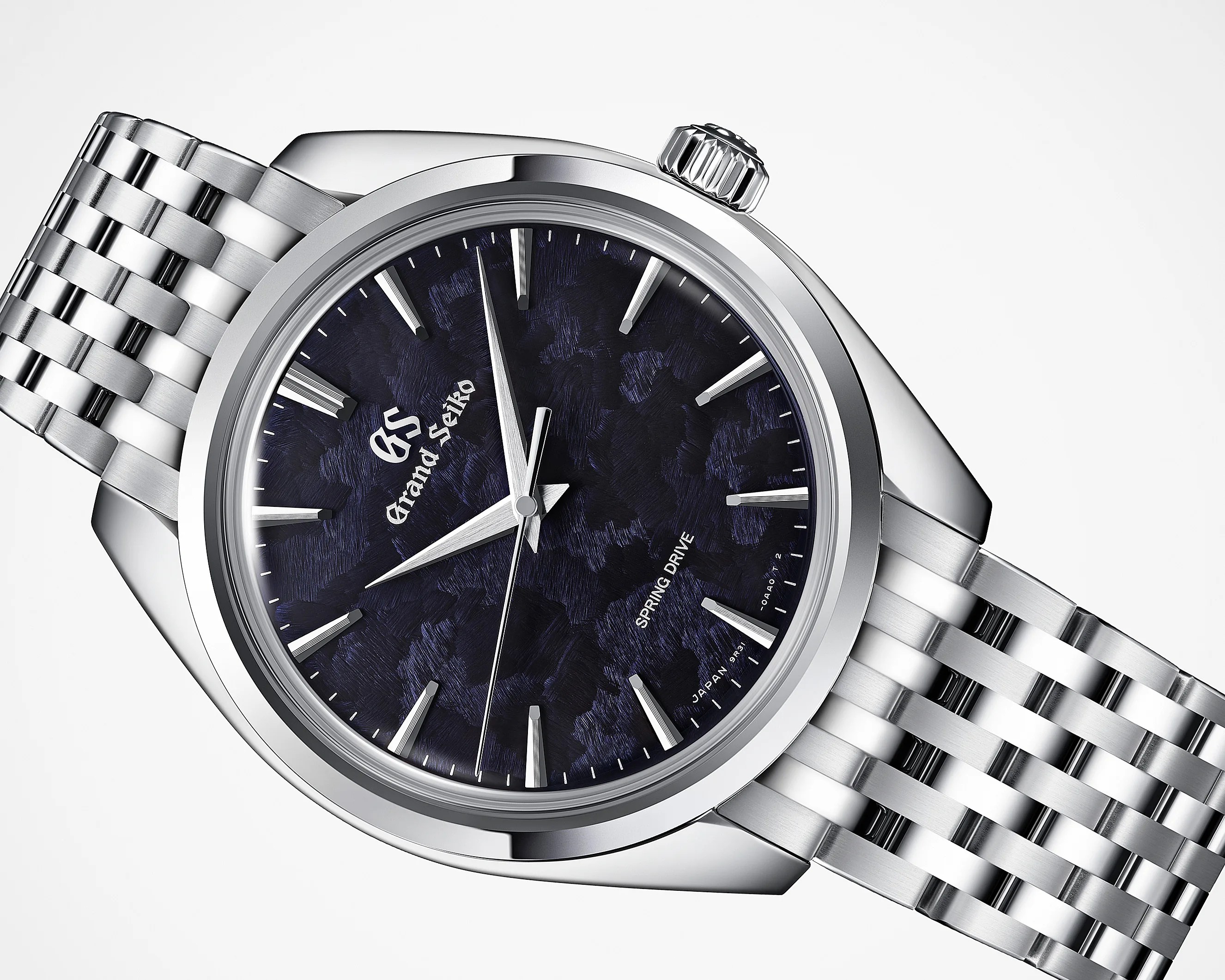 Silver stainless steel Grand Seiko wristwatch with textured dark blue dial and silver hour markers.