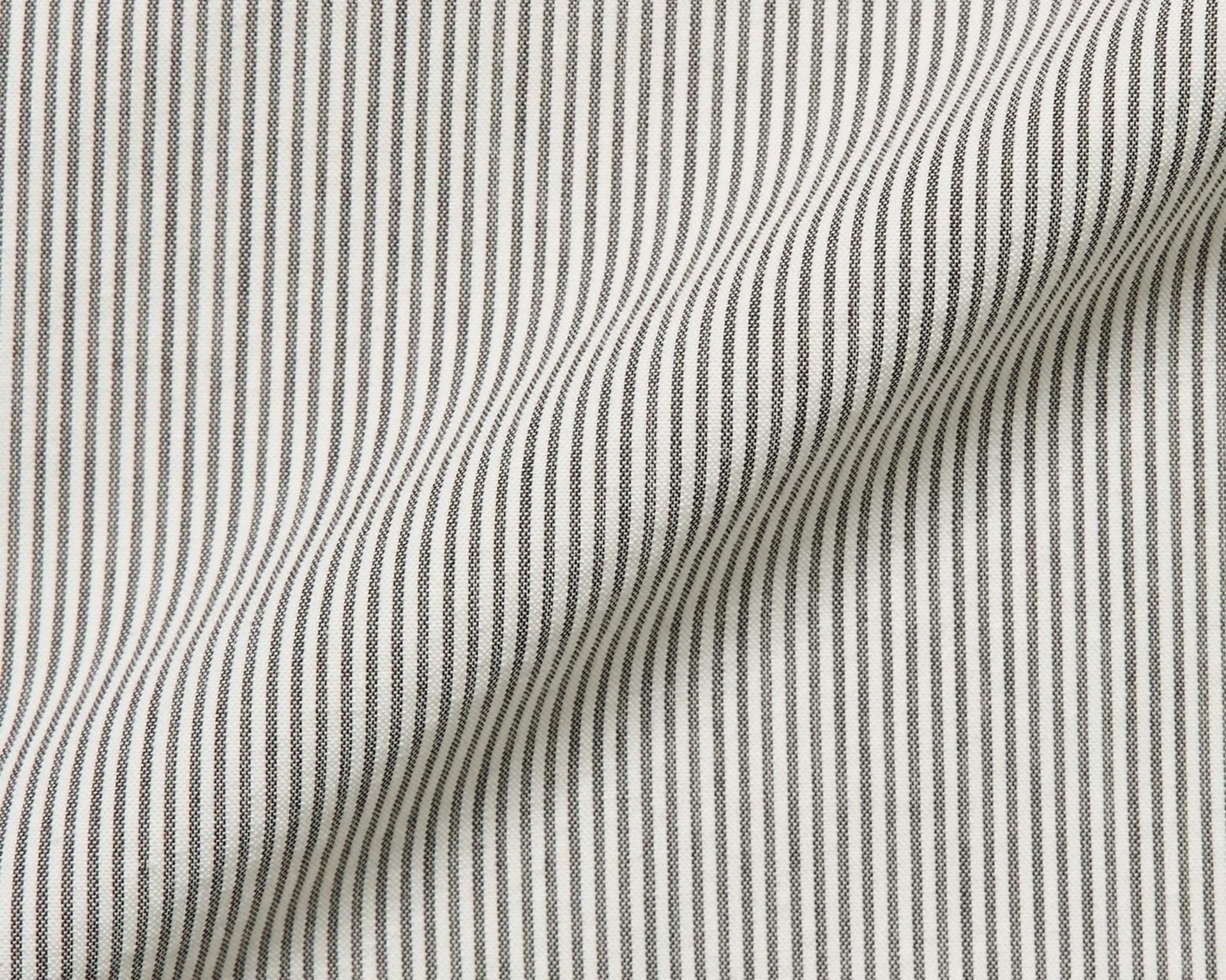 White fabric with thin vertical black pinstripes and slight folds.