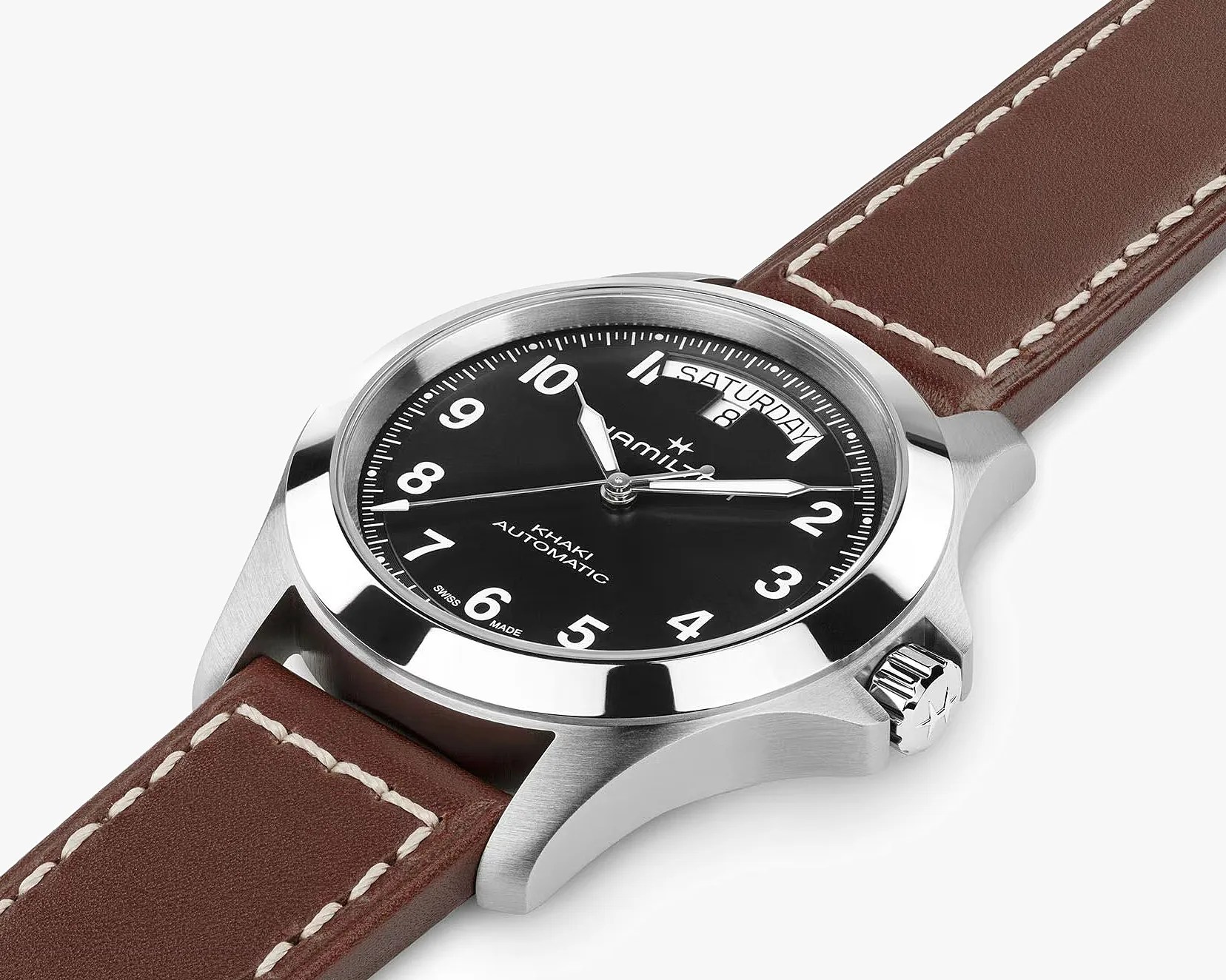 Stainless steel wristwatch with black dial, white numerals, day-date display, and brown leather strap with white stitching.