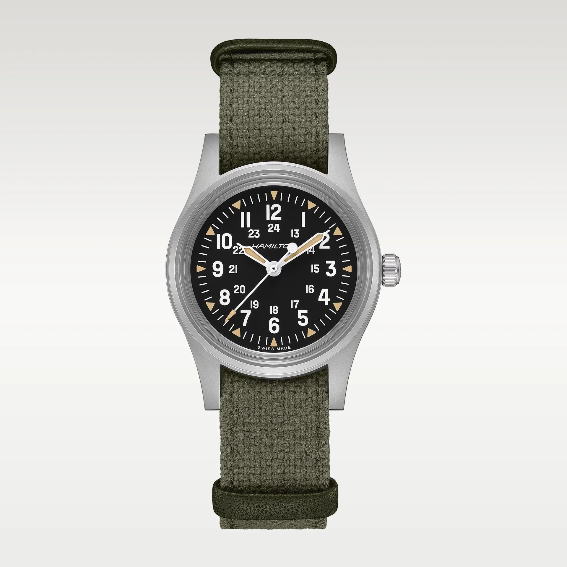 Silver Hamilton watch with black dial, white numerals, beige hands, and olive green fabric strap.