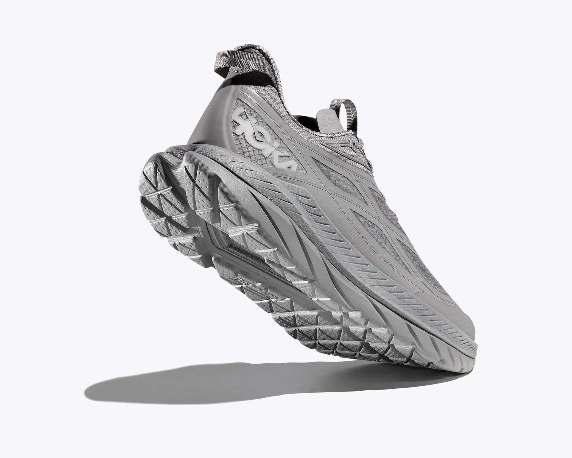Gray Hoka running shoe with thick textured sole and pull tabs on heel and tongue.