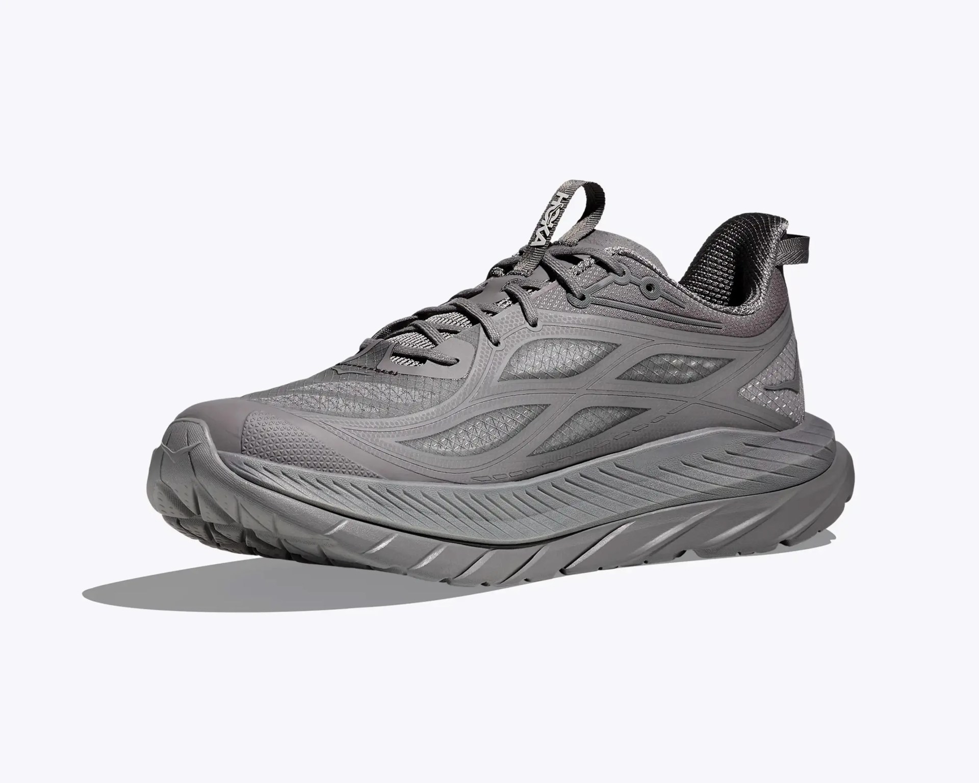 Gray athletic running shoe with thick sole and mesh upper, viewed from the side.