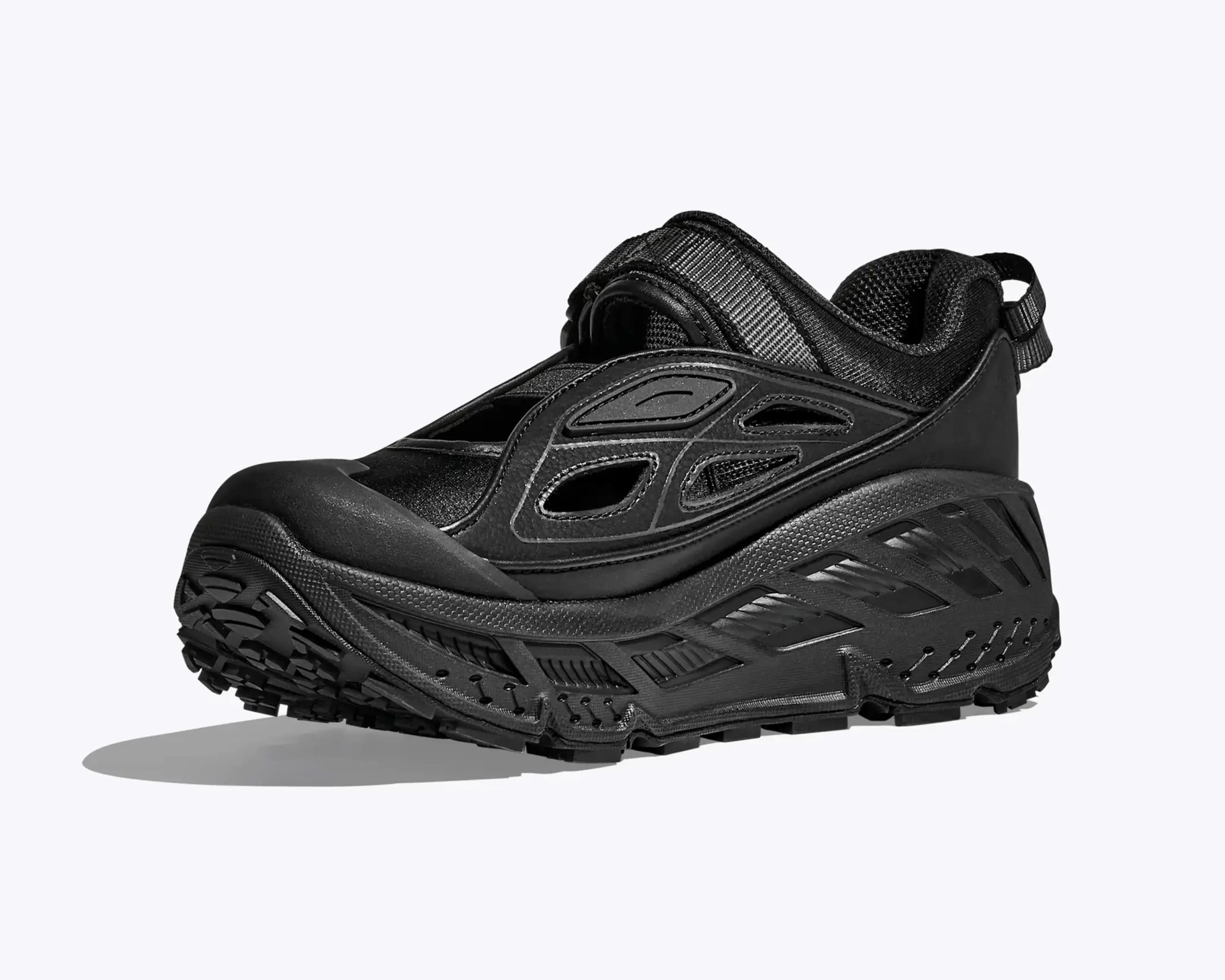 Chunky black athletic shoe with mesh and synthetic overlays and a thick textured sole.