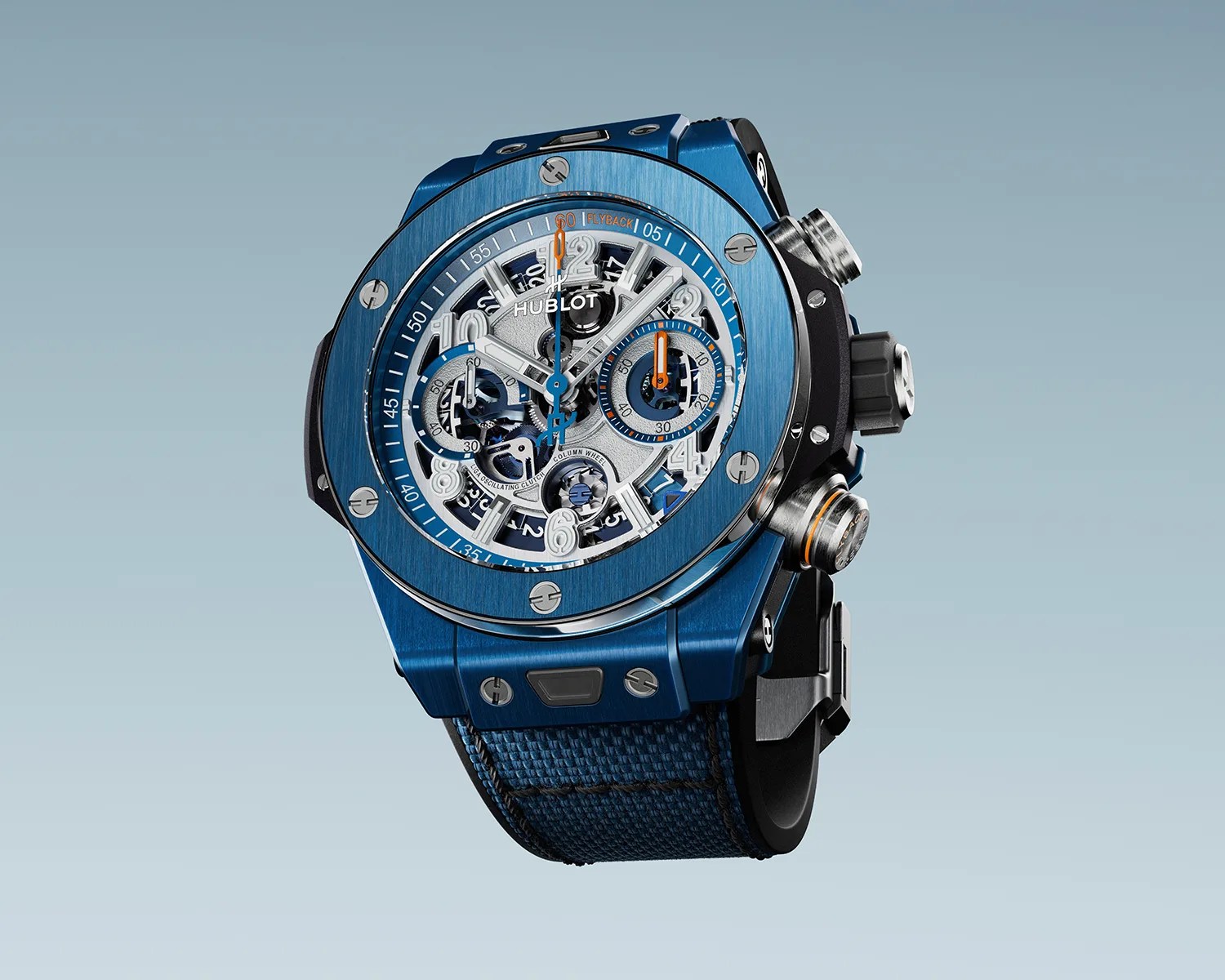 Blue Hublot wristwatch with a skeleton dial, silver and orange accents, and a blue fabric strap.
