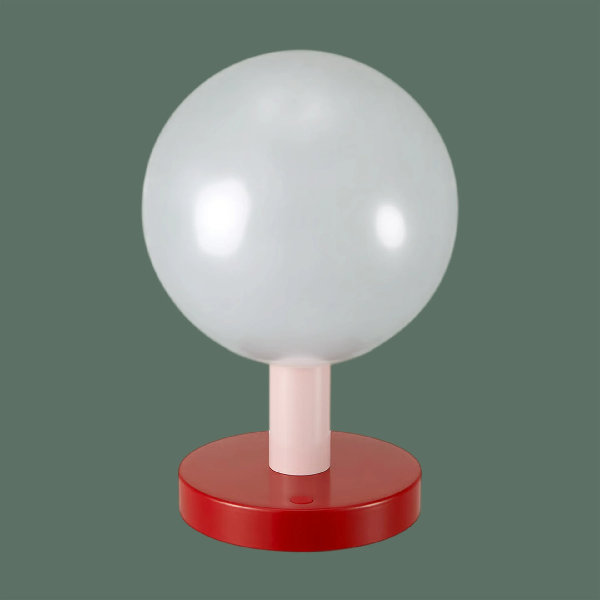 Table lamp with a large white spherical shade, pink stem, and red circular base on a green background.