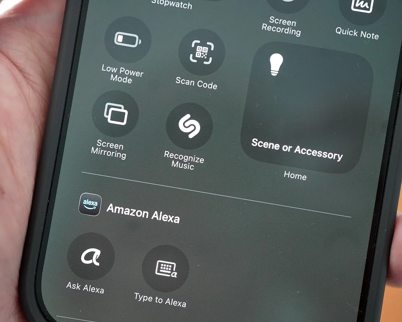 Smartphone screen showing control center with options like Low Power Mode, Scan Code, Screen Mirroring, Recognize Music, and Amazon Alexa features.