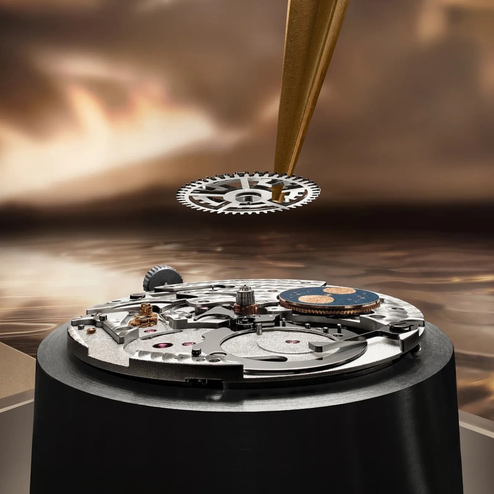 Close-up of a watchmaker's tool holding a small gear above a mechanical watch movement on a black stand.