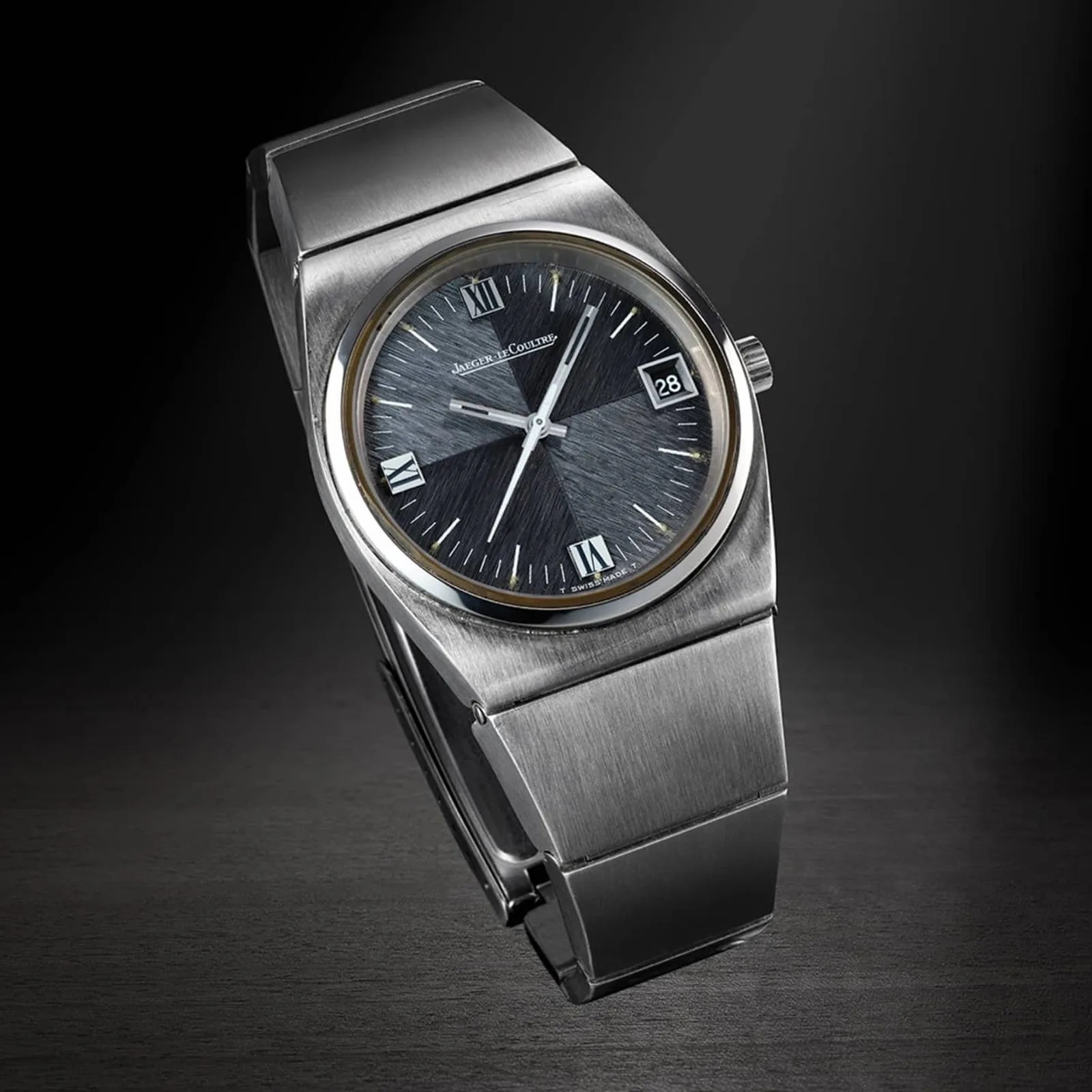 Stainless steel Jaeger-LeCoultre wristwatch with a textured black dial, Roman numerals, and date display.