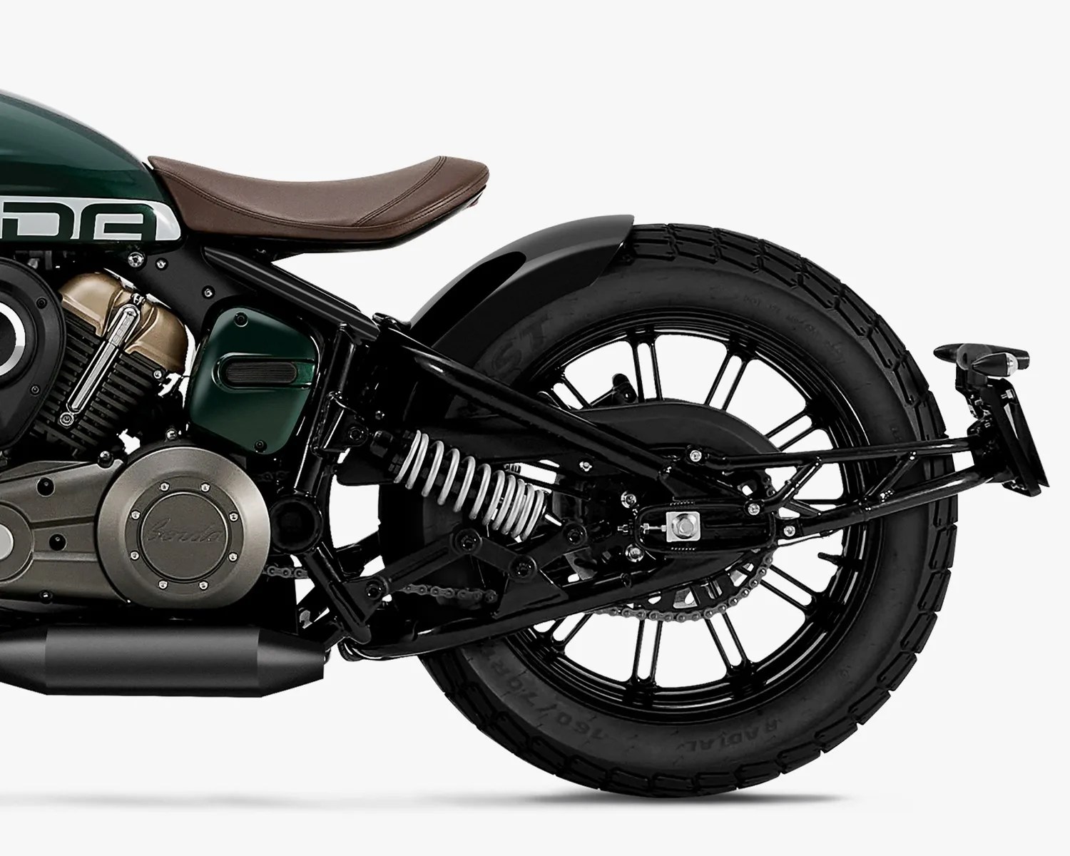 Rear section of a green motorcycle with brown leather seat, black frame, and large black rear tire.