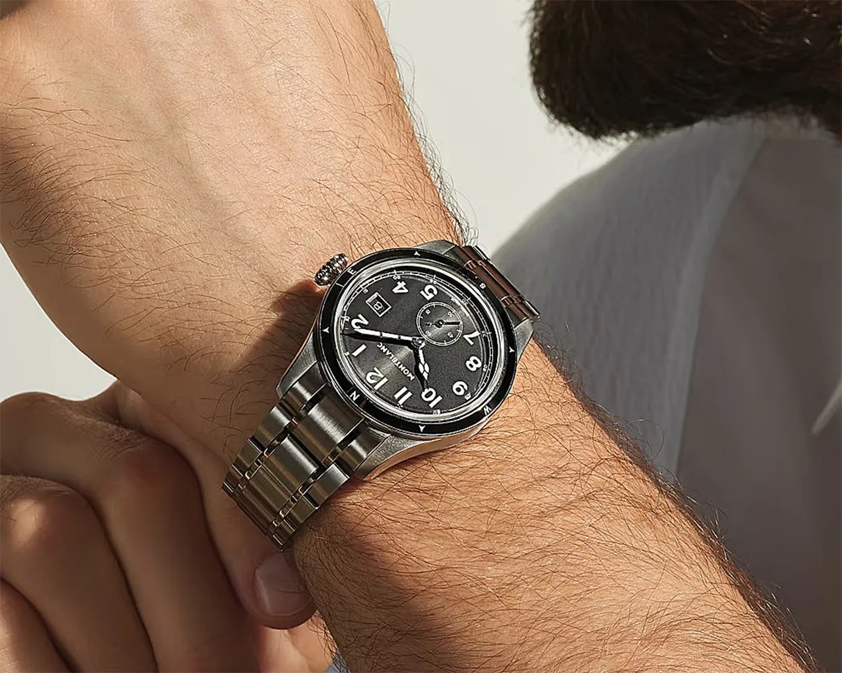 Montblanc stainless steel wristwatch with black dial and white numerals worn on a wrist.