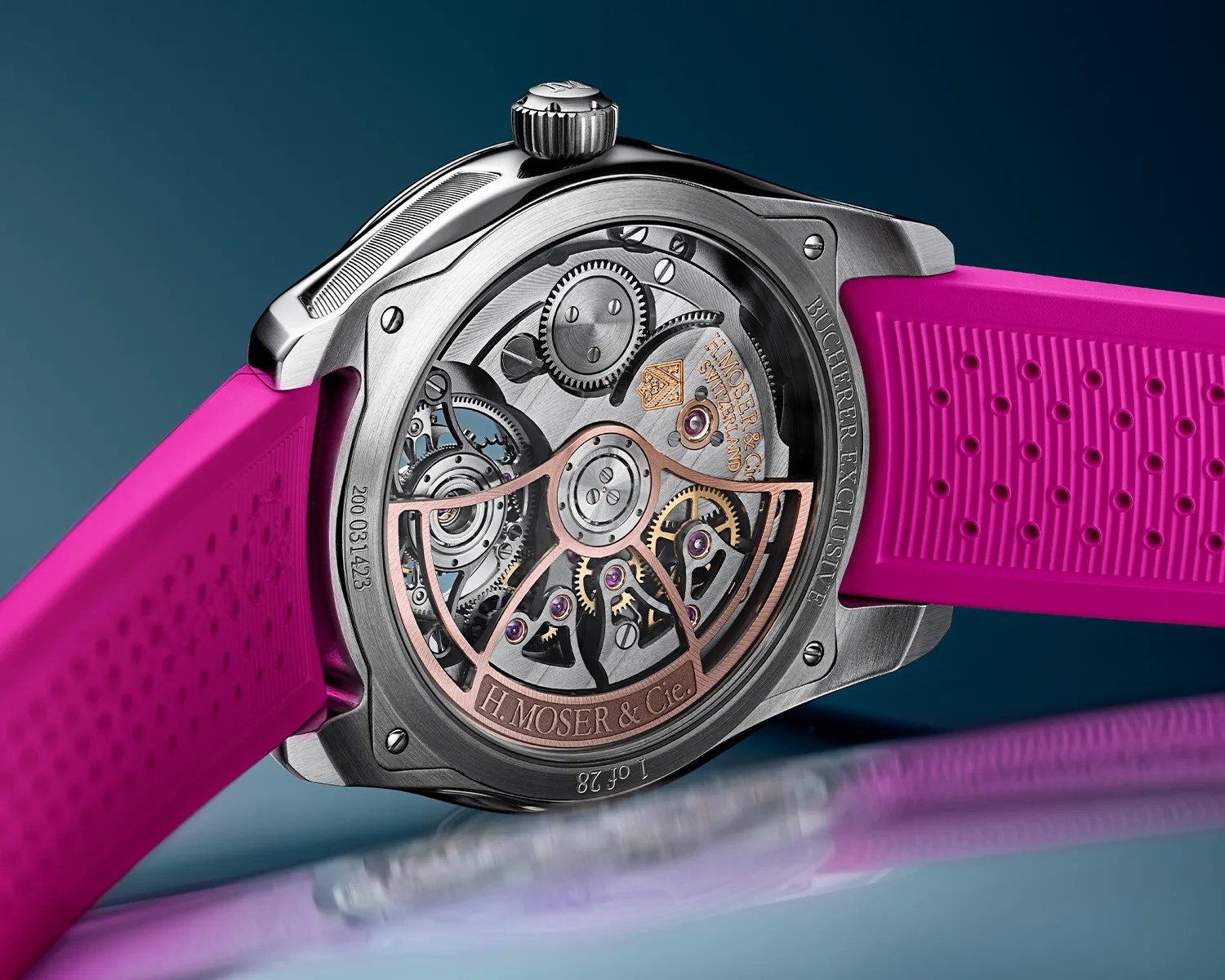 Close-up of the back of a silver H. Moser & Cie watch with visible gears and a bright pink rubber strap.