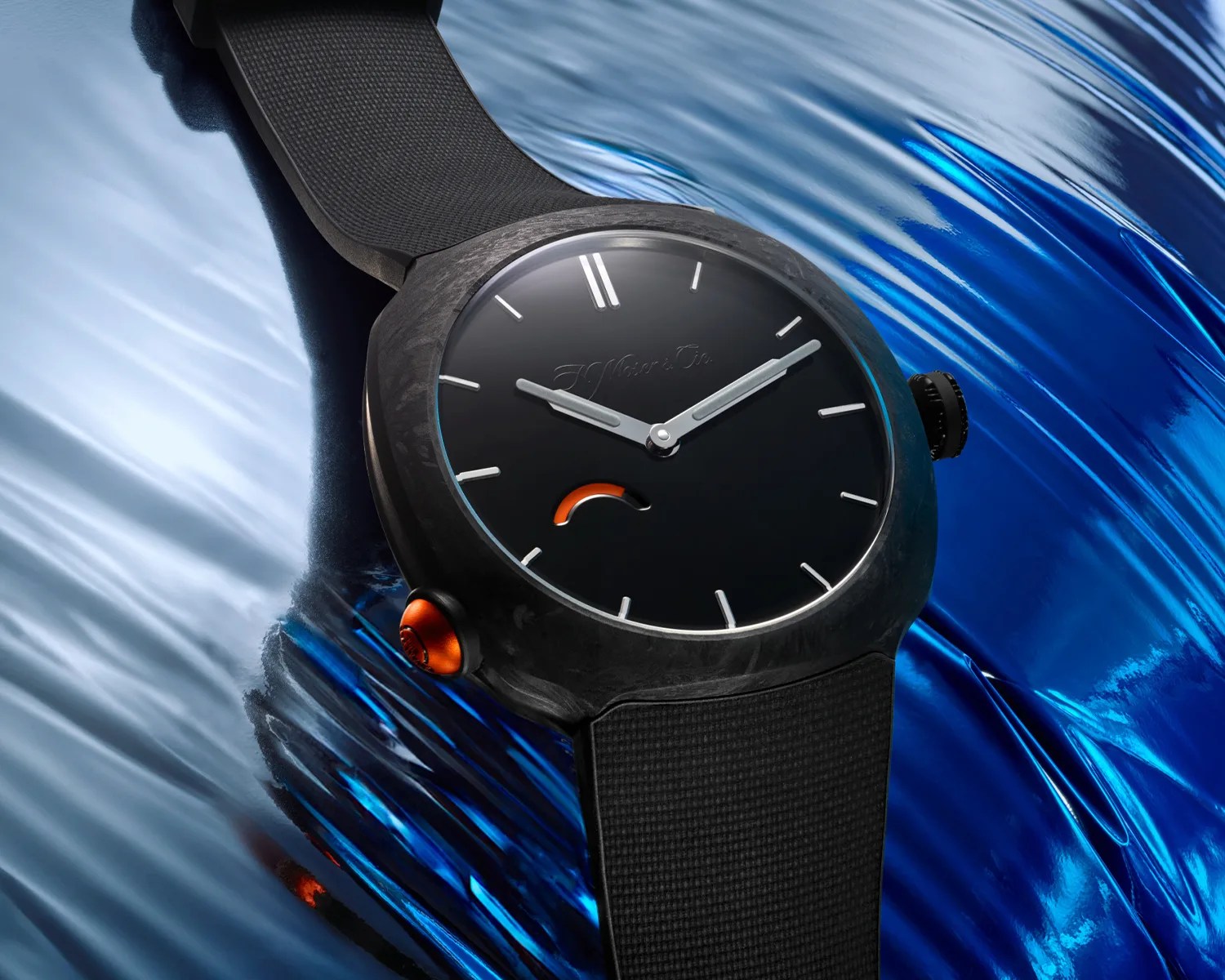 Black wristwatch with a matte black dial, silver hands, orange accent near the 7 o'clock position, and black textured strap.