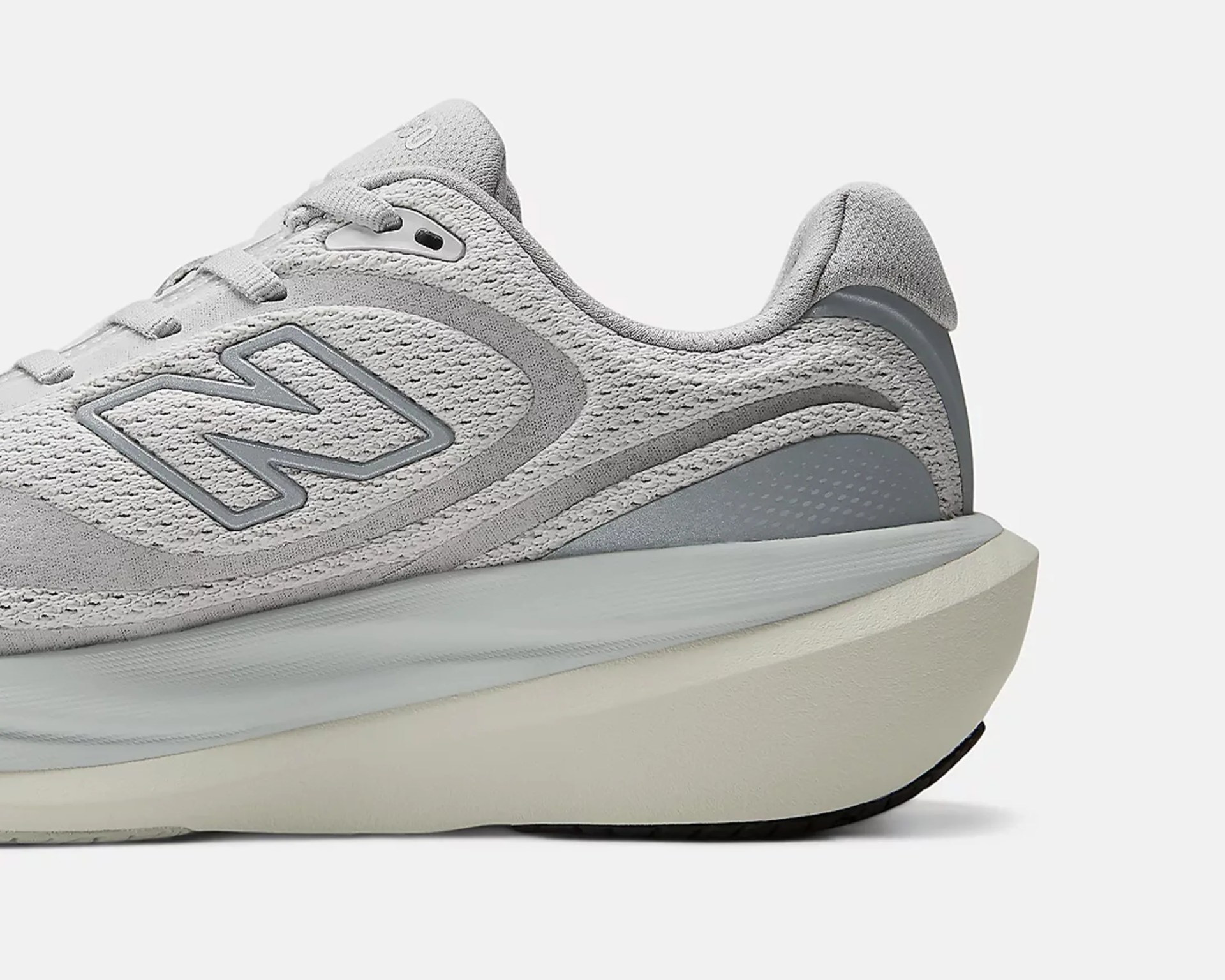 Light gray New Balance sneaker with mesh upper and thick white sole.