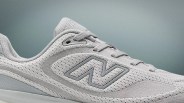 Light gray New Balance sneaker with mesh fabric and suede accents, featuring the "N" logo on the side.