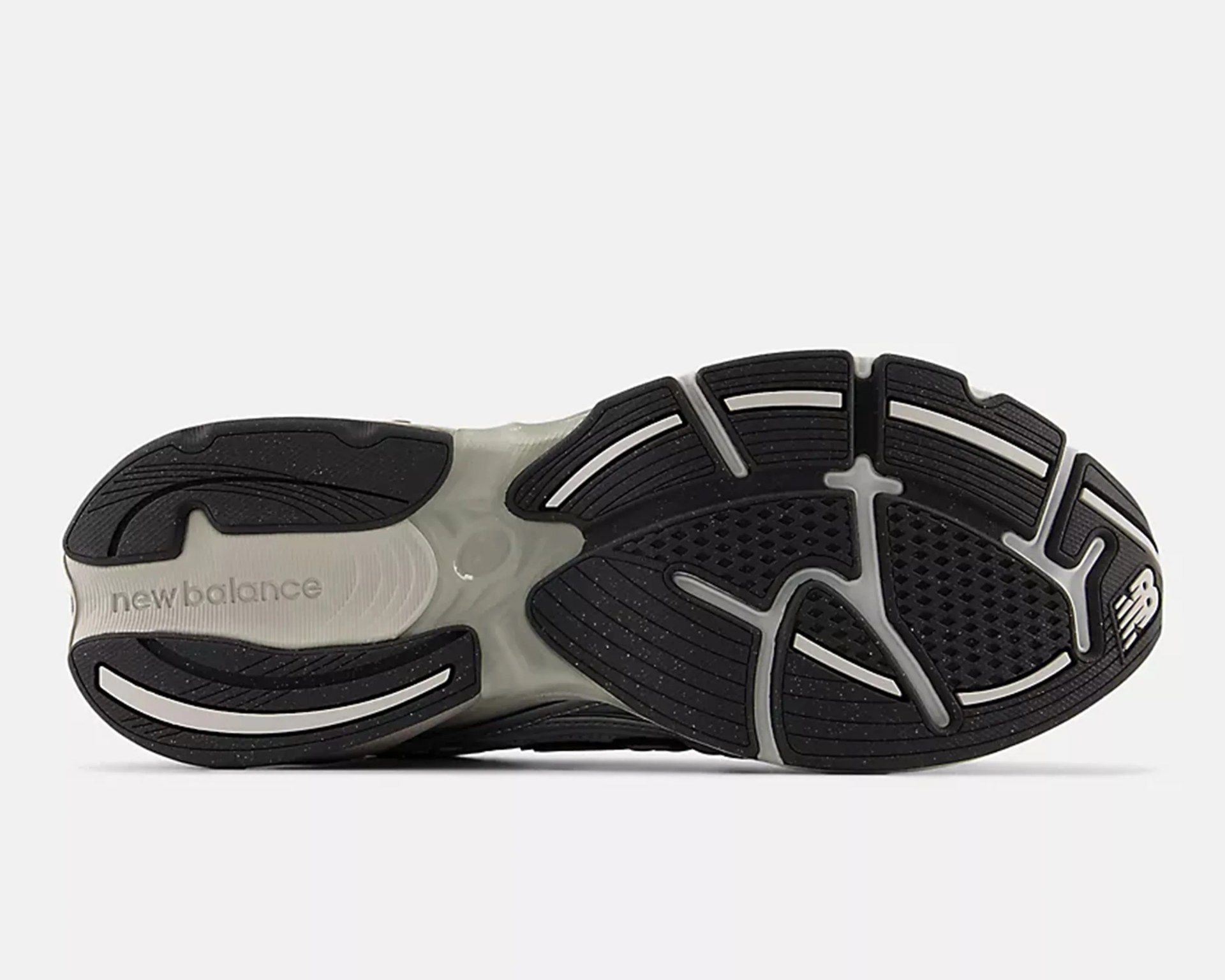 Black and gray New Balance shoe sole with textured grip and logo visible.