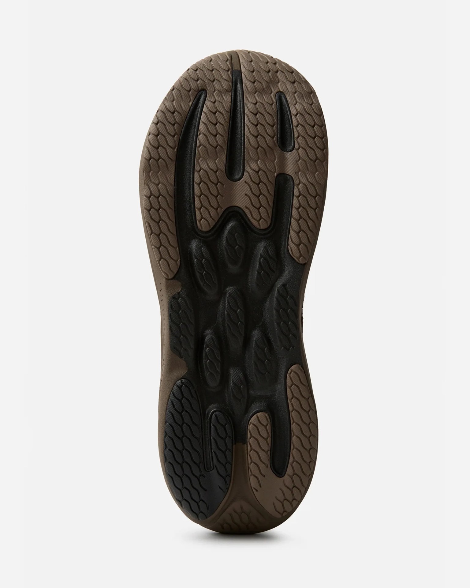 Brown and black rubber shoe sole with textured tread pattern on a white background.