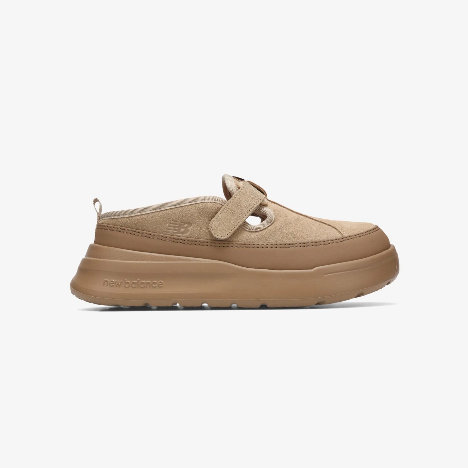 Beige suede New Balance slip-on shoe with a thick rubber sole and adjustable strap.