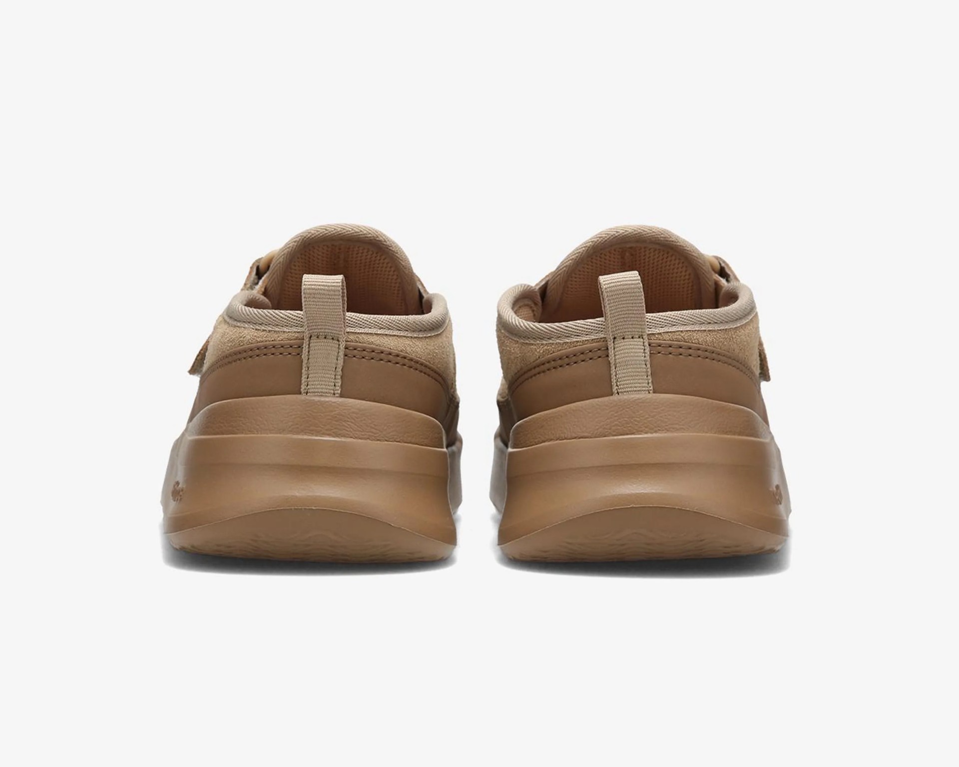 Pair of tan slip-on shoes with fabric pull tabs at the back, shown from the rear.
