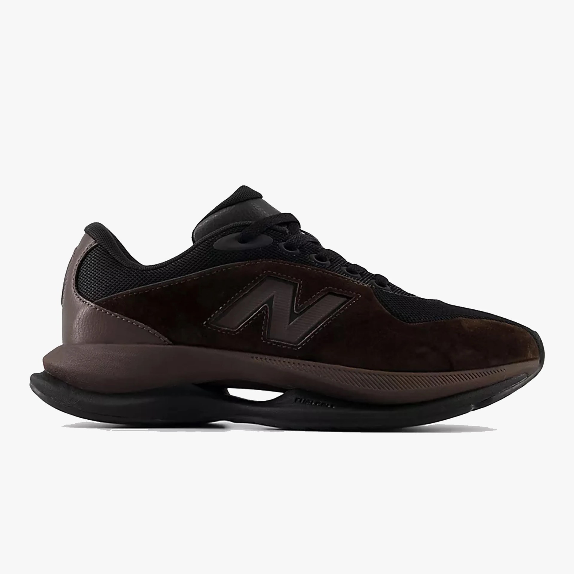 Dark brown and black New Balance sneaker with mesh and suede upper and cushioned sole.